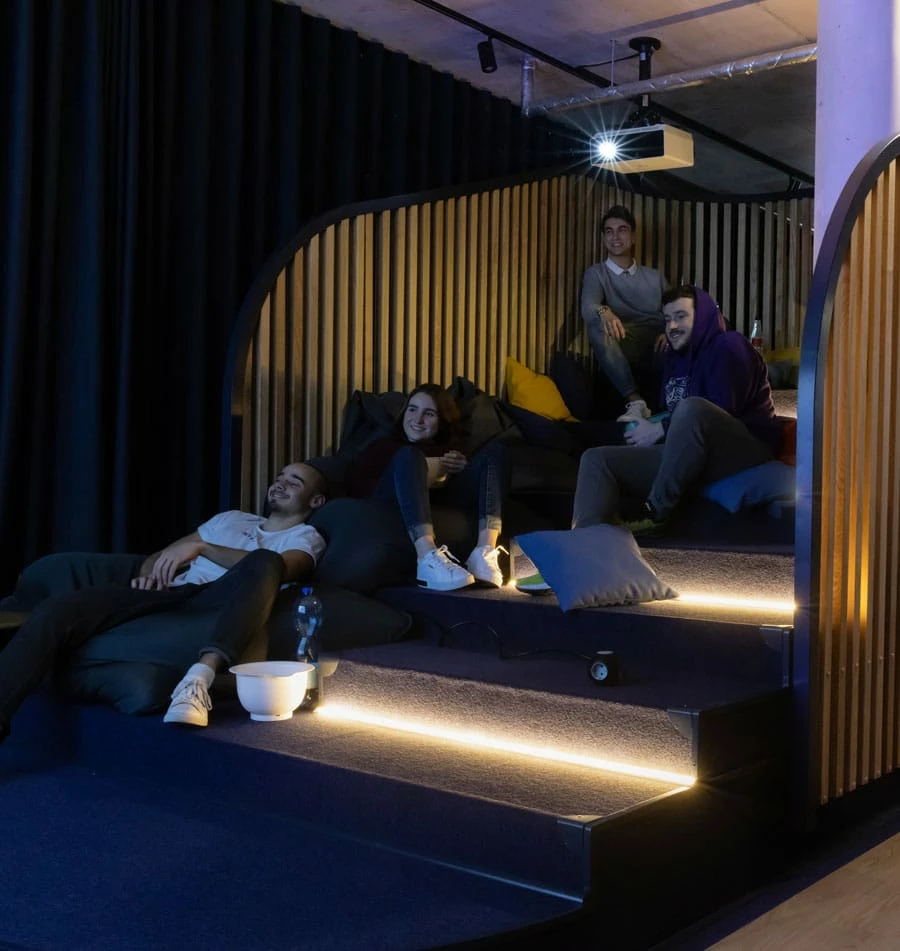 Students enjoying the cinema room at Basecamp Dortmund student house