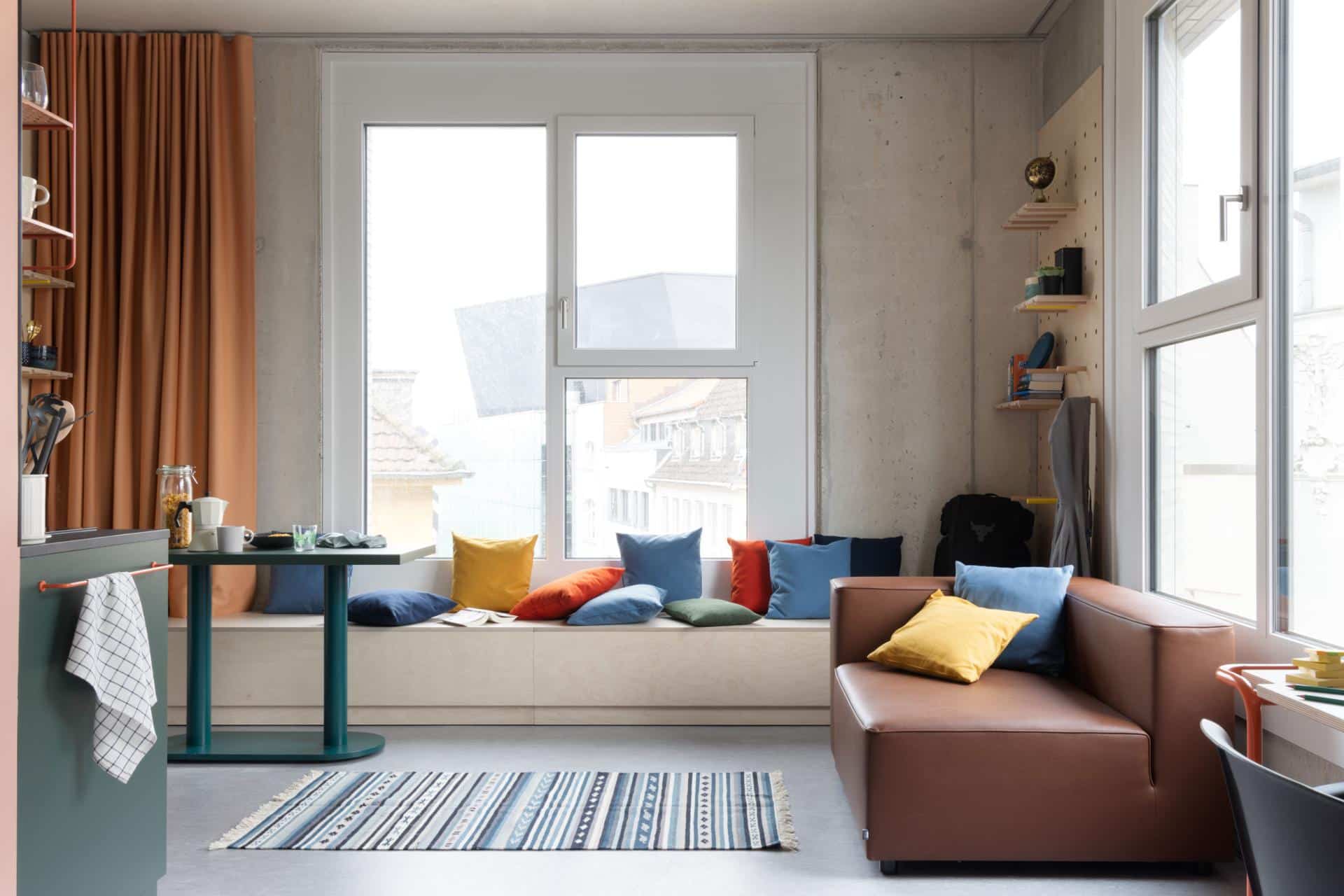 Lounge area of a single XL room with kitchenette at Basecamp Dortmund student housing