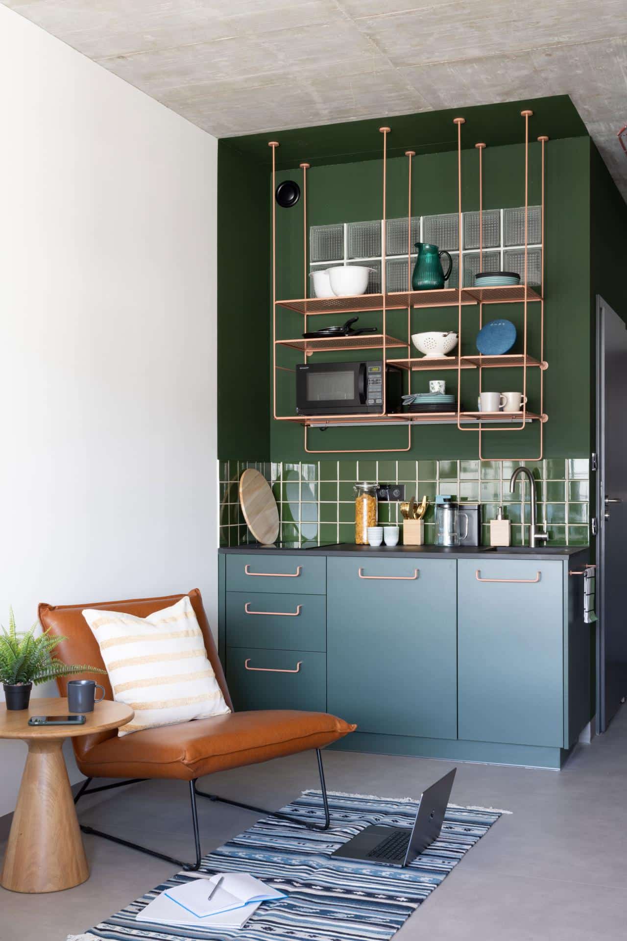 Lounge and kitchen area of a large studio at Basecamp Katowice student dormitory