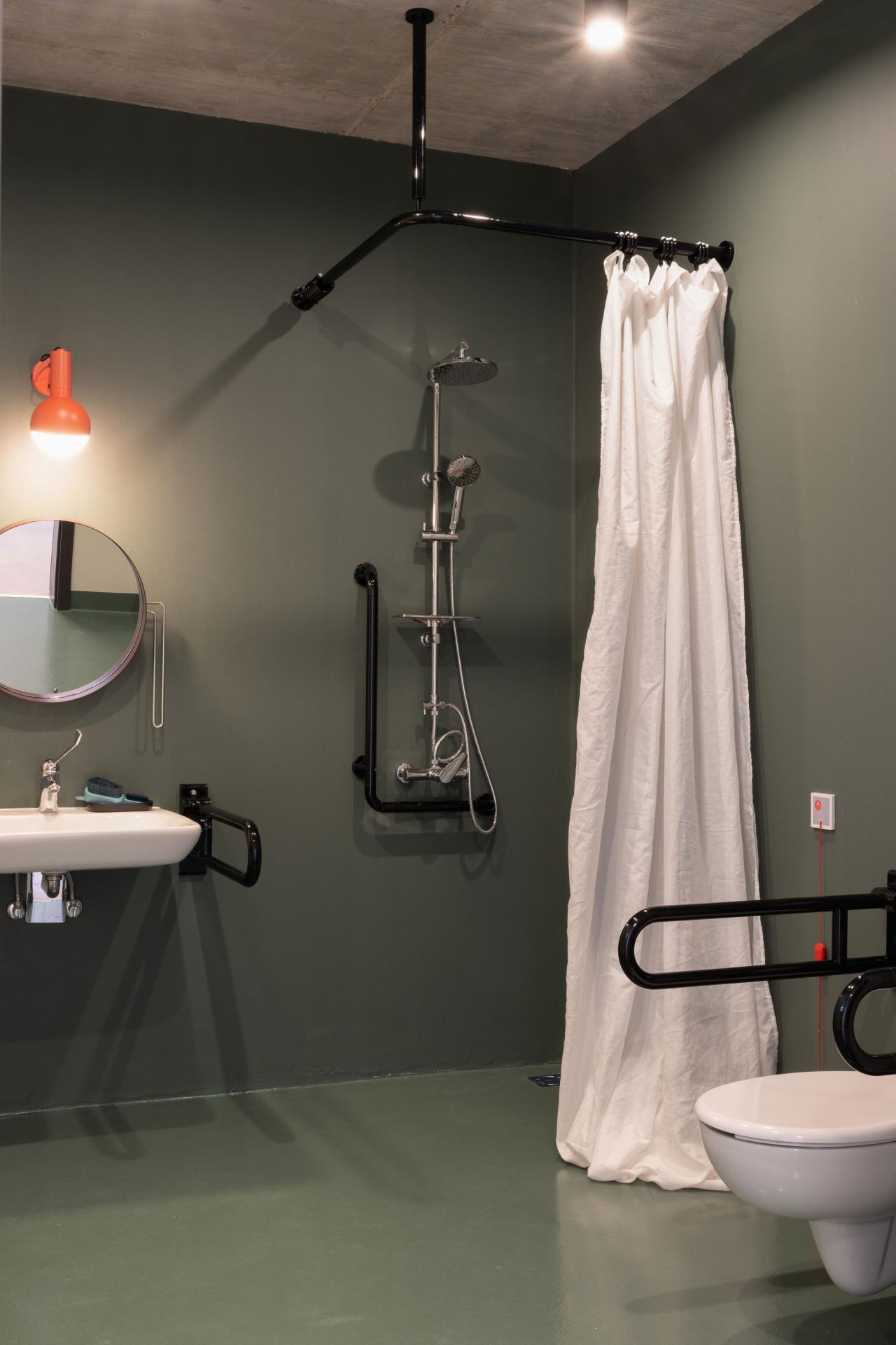 Private bathroom showing shower, toilet, sink and mirror in one of the accessible rooms at Basecamp Katowice student accommodation