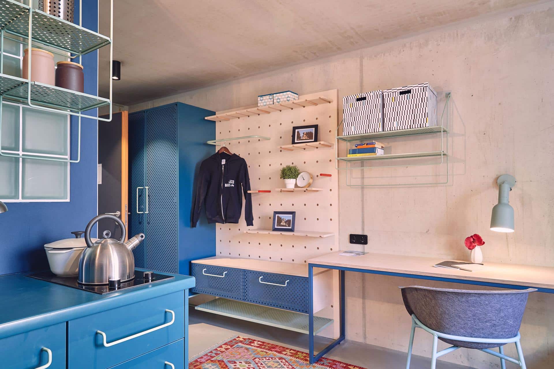 Blue storage space and kitchenette in a single room at Basecamp Leipzig student accommodation