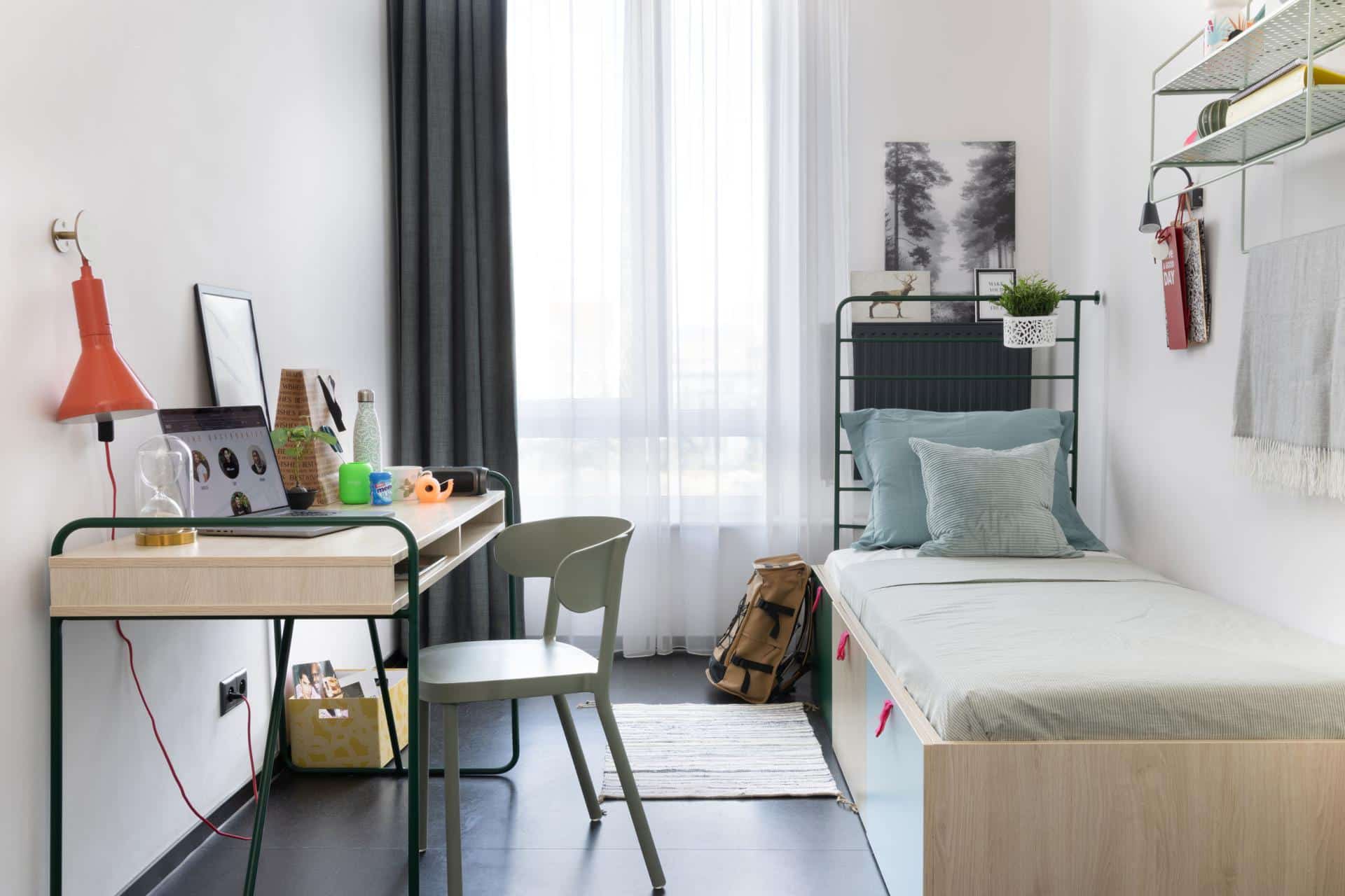 desk and bed in a single accessible room Basecamp at Łódź Rewolucji student accommodation