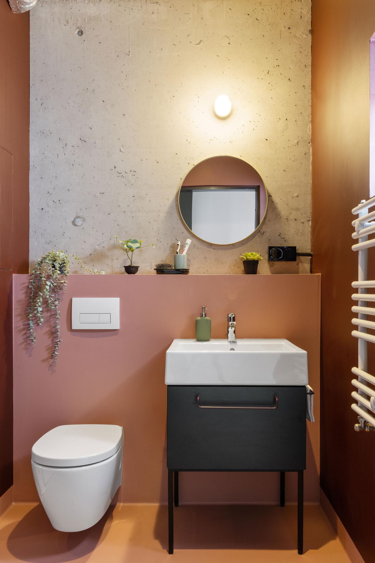 Sink, toilet and mirror in the private bathroom of a student room at Basecamp Wroclaw dormitory