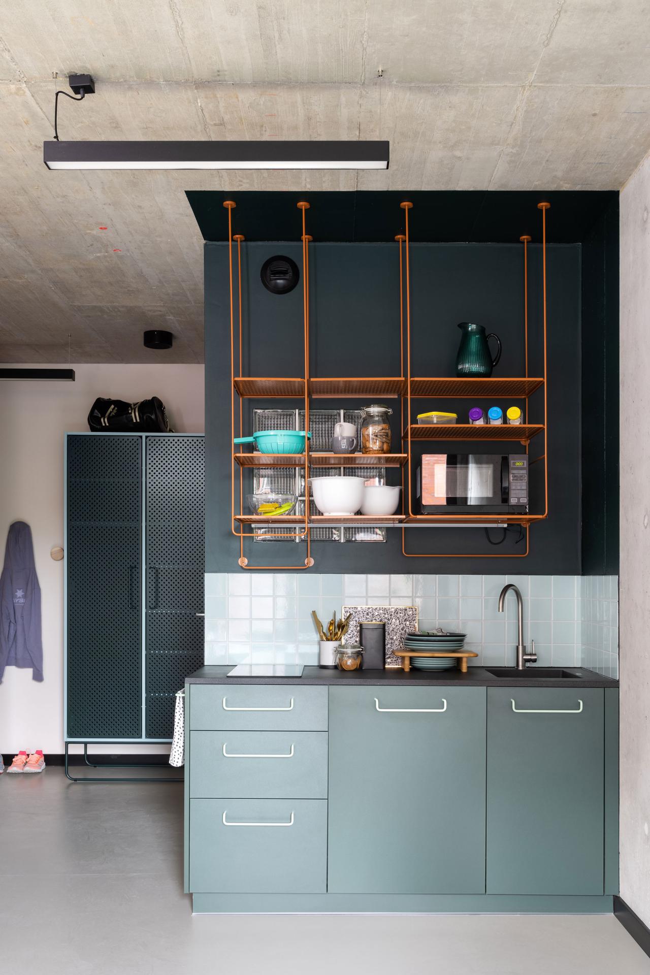 Studio room kitchenette with a hob and sink at Basecamp Wroclaw dormitory