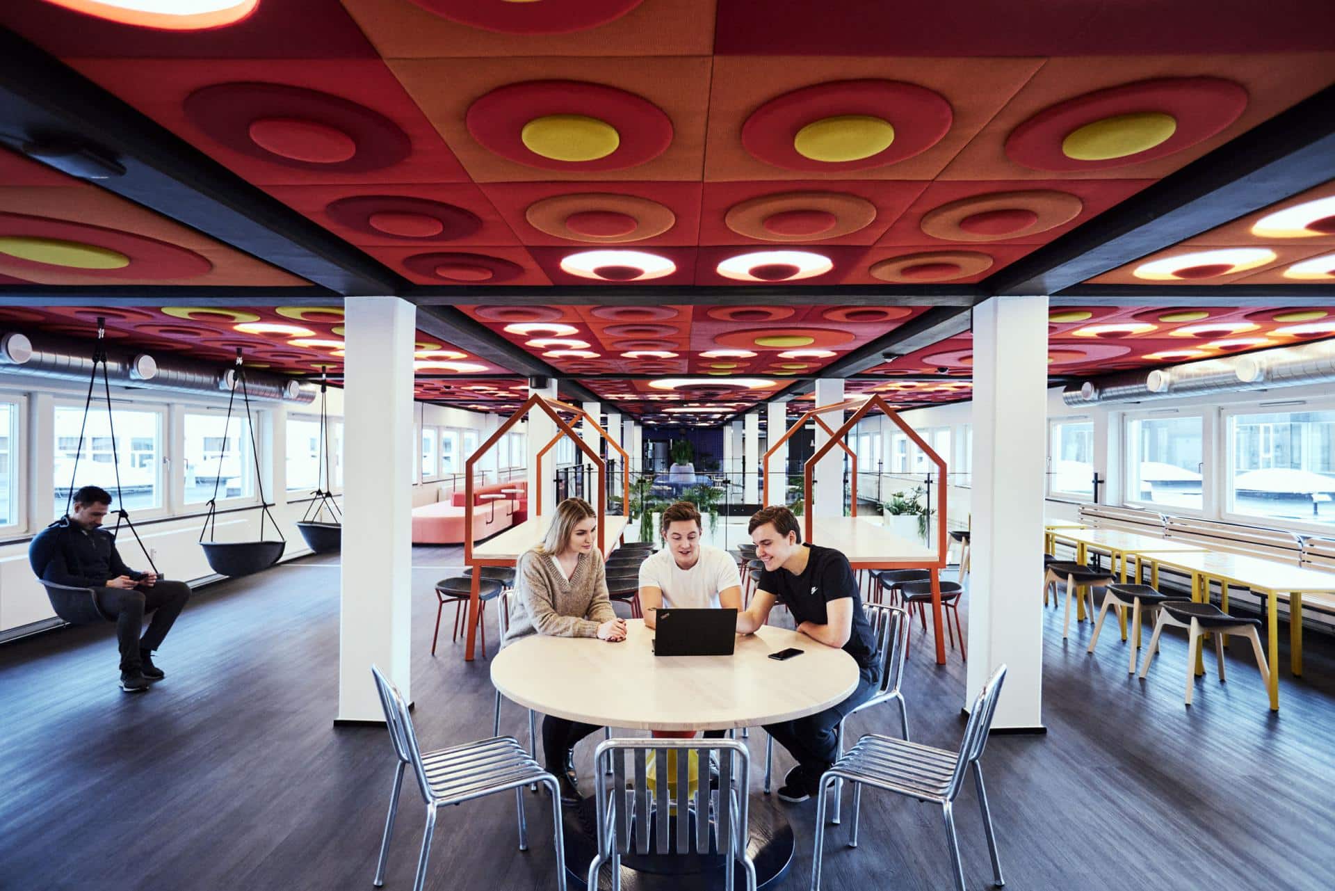 A group of students doing university work in the spacious and modern study area of Basecam Copenhagen South Campus accommodation