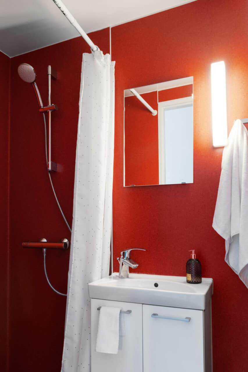 Private bathroom showing shower, sink and mirror in one of the rooms at Basecamp Copenhagen student accommodation