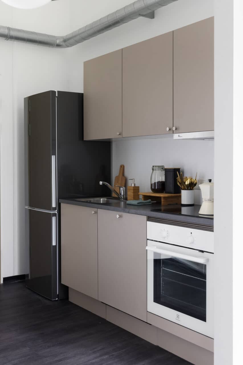 Private kitchen with a large fridge in a student room at Basecamp Lyngby student dorm