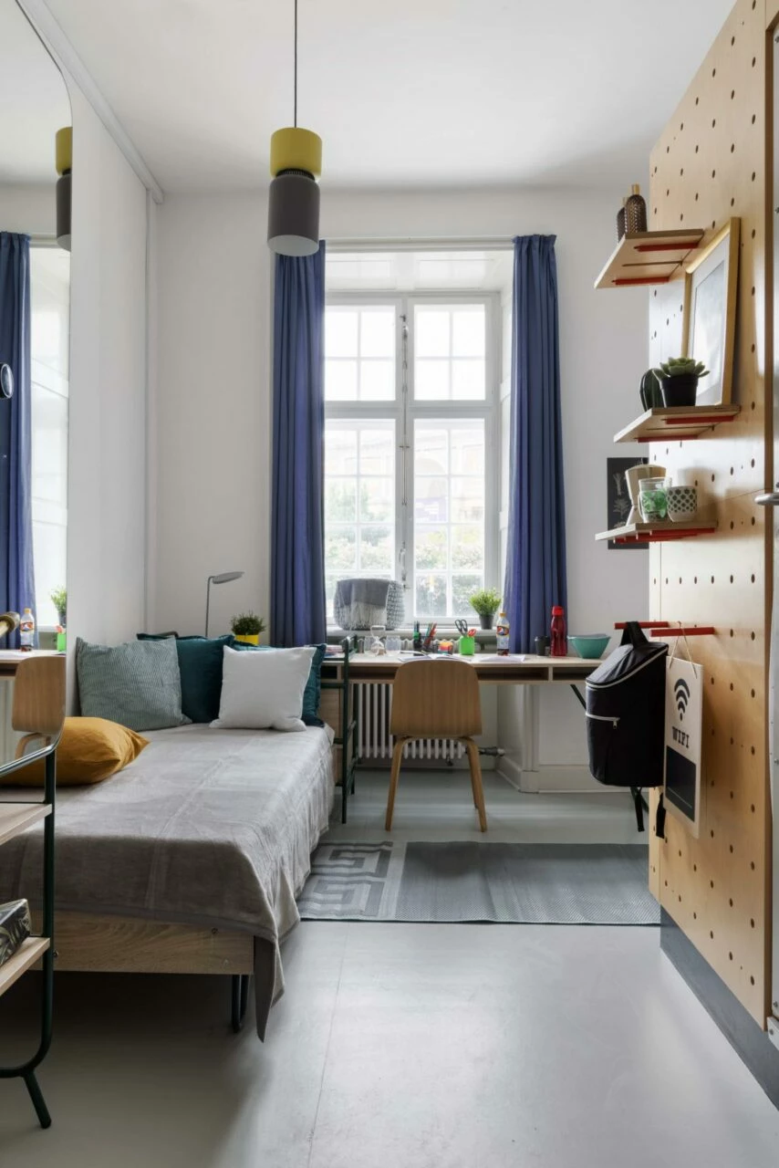 bed and study area of a student room at Basecamp Copenhagen student accommodation