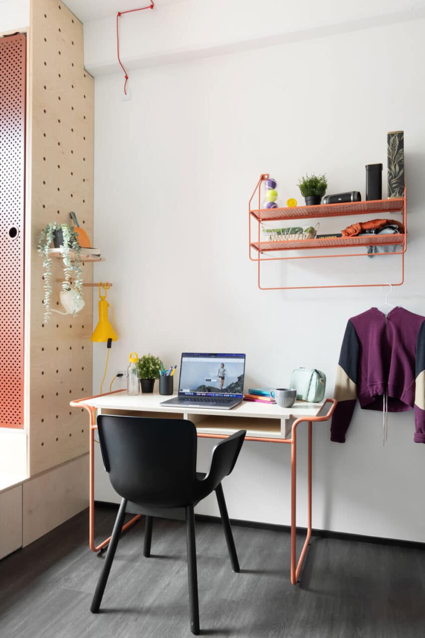 bed with shelves and a view of Copenhagen streets at Basecamp South Campus student housing