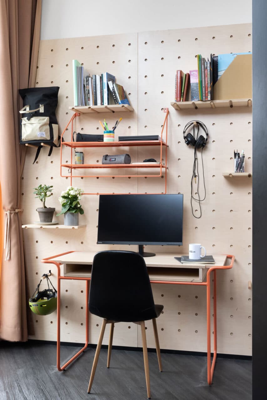 desk and shelves in a study area of a private studio room at Basecamp Copenhagen dorm