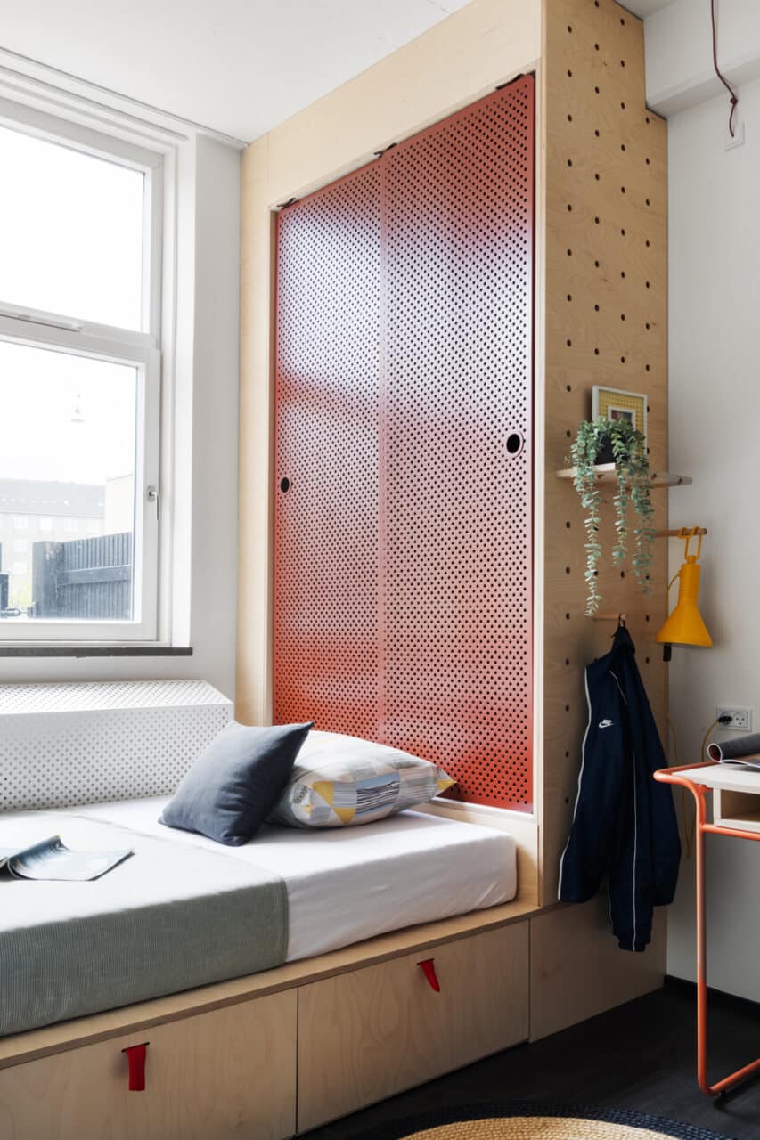 Bed and wardrobe in a private studio room at Basecamp Copenhagen dorm