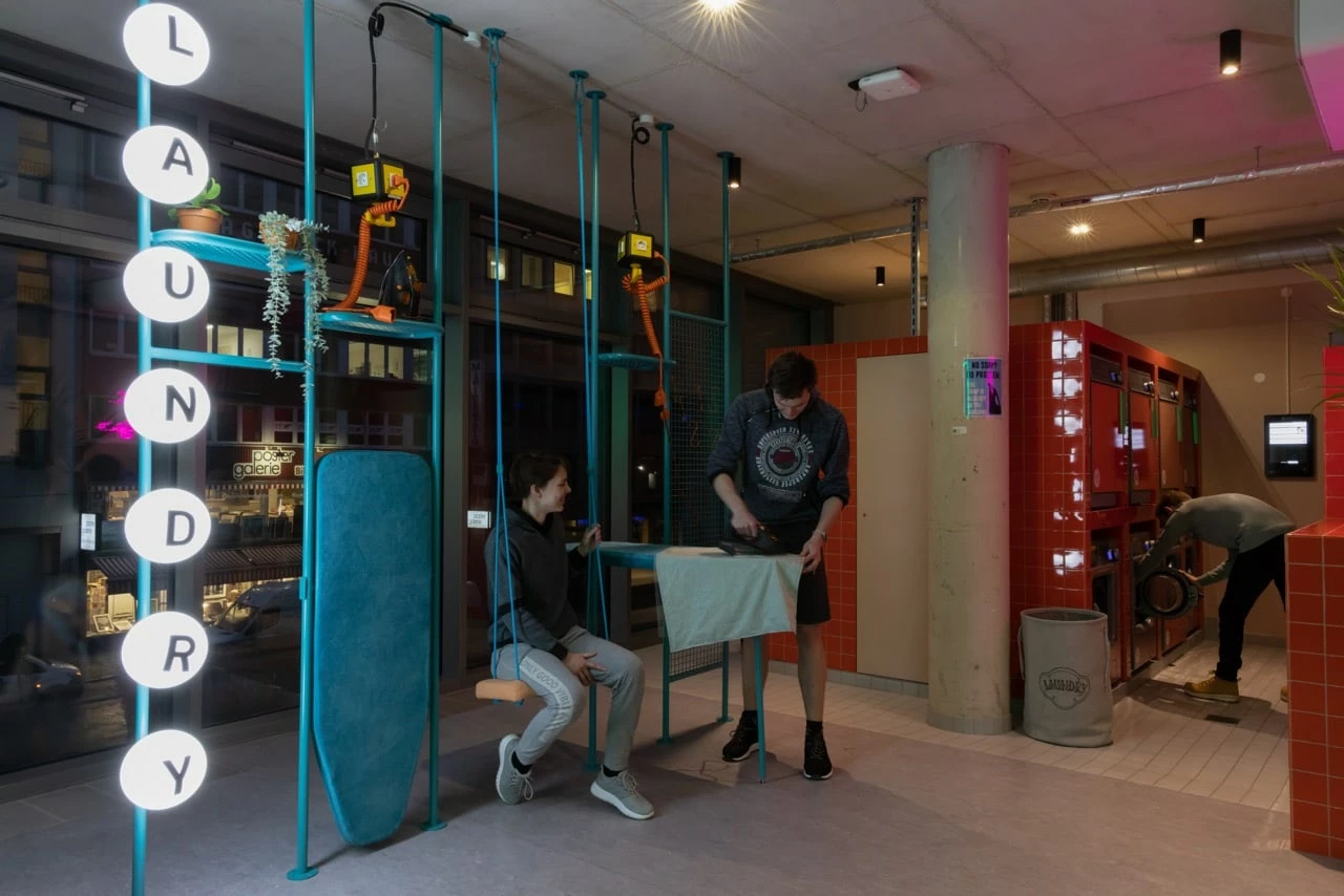 Sutdents ironing their clothes at Basecamp Dortmund's laundry facilities