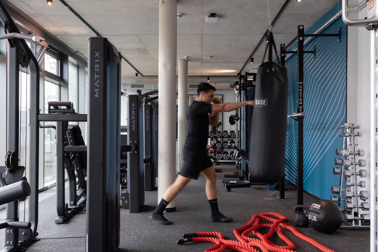 A student trains with a punching bag at Basecamp Dortmund dormitory's gym