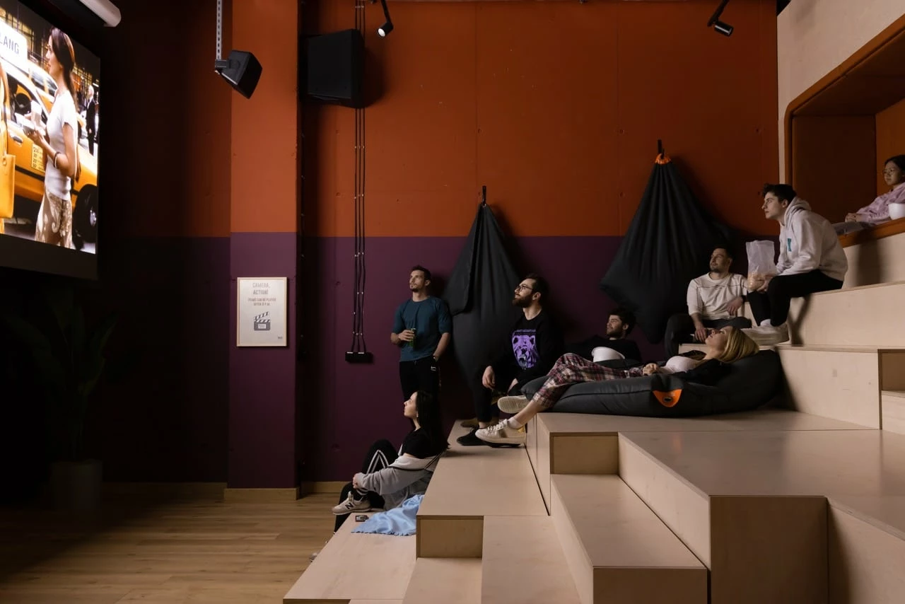 Students enjoying a film in the communal cinema at Basecamp Katowice student dorm