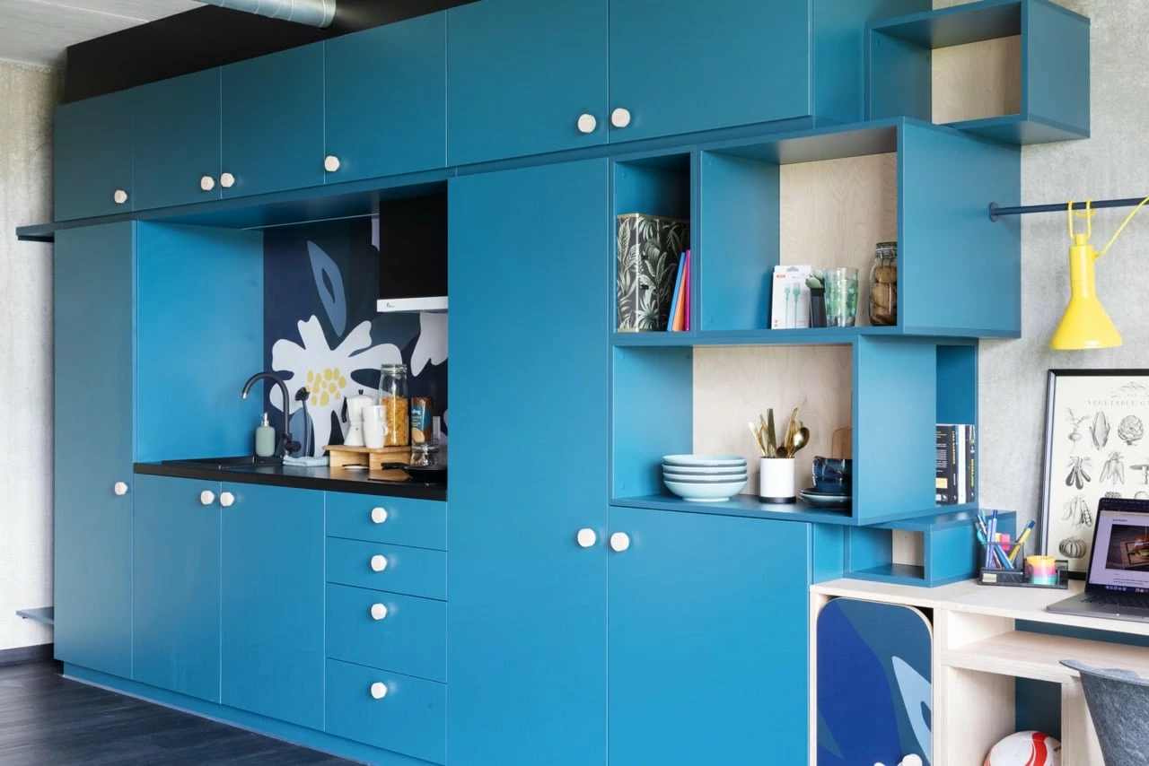 View of a large studio room for students at Basecamp Lyngby dorm showing the kitchen area