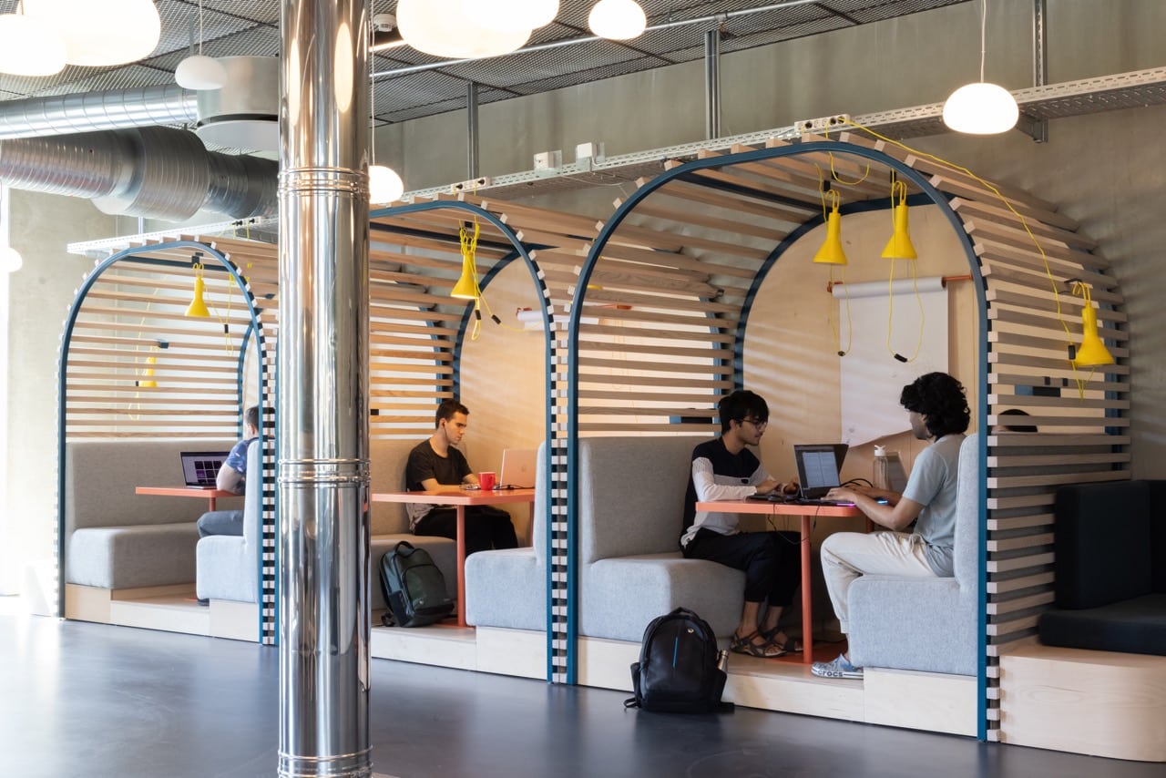 a group of students doing university work in the communal study area at Basecamp Lyngby student accommodation