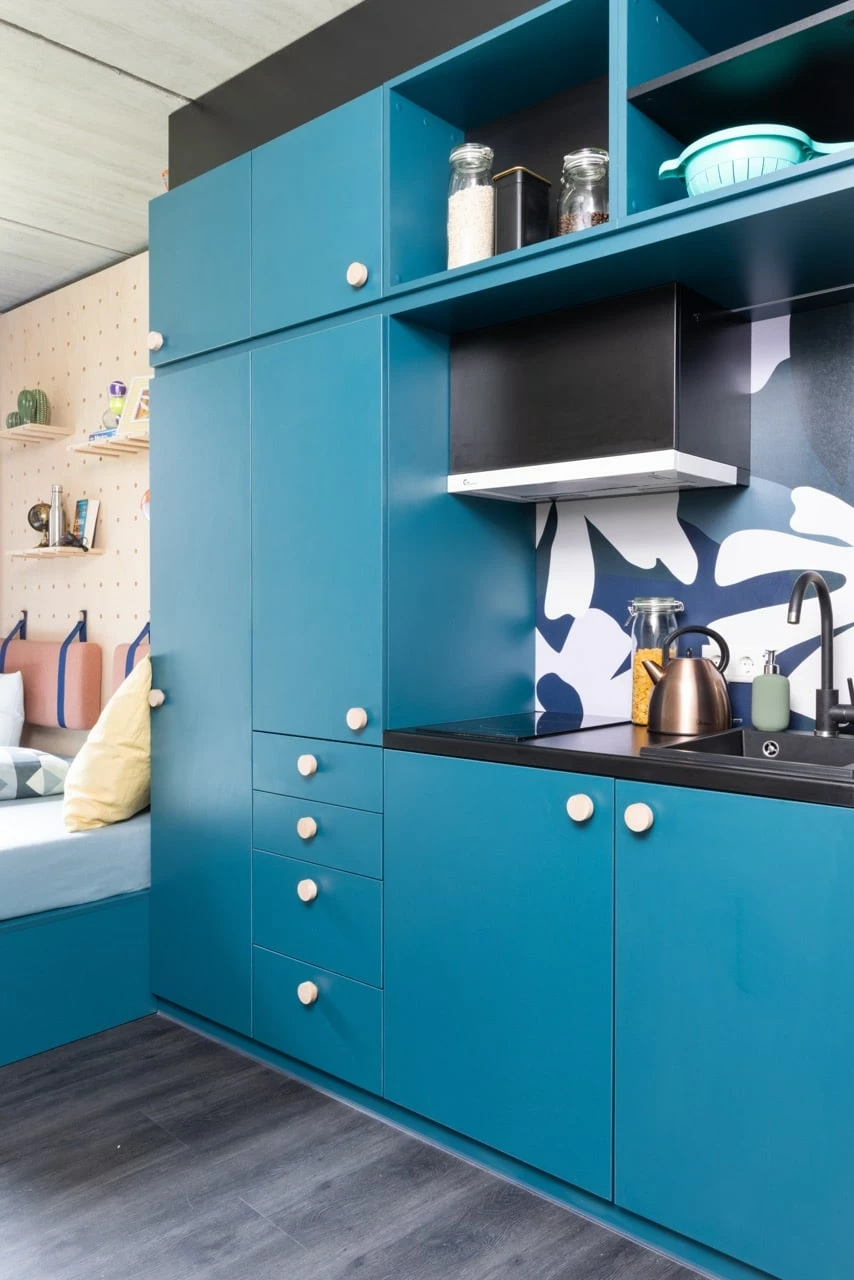 Blue kitchen with storage room in a private student room at Basecamp Lyngby student house