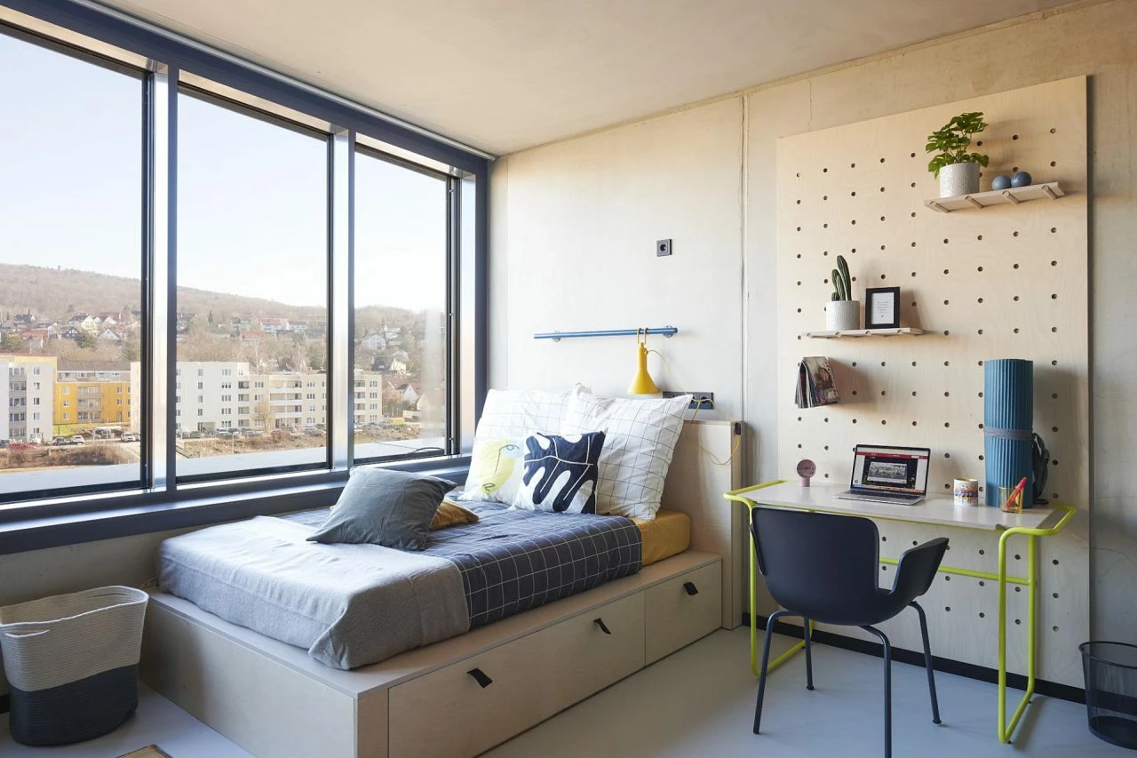 Bed and views in a studio penthouse room at Basecamp Gottingen