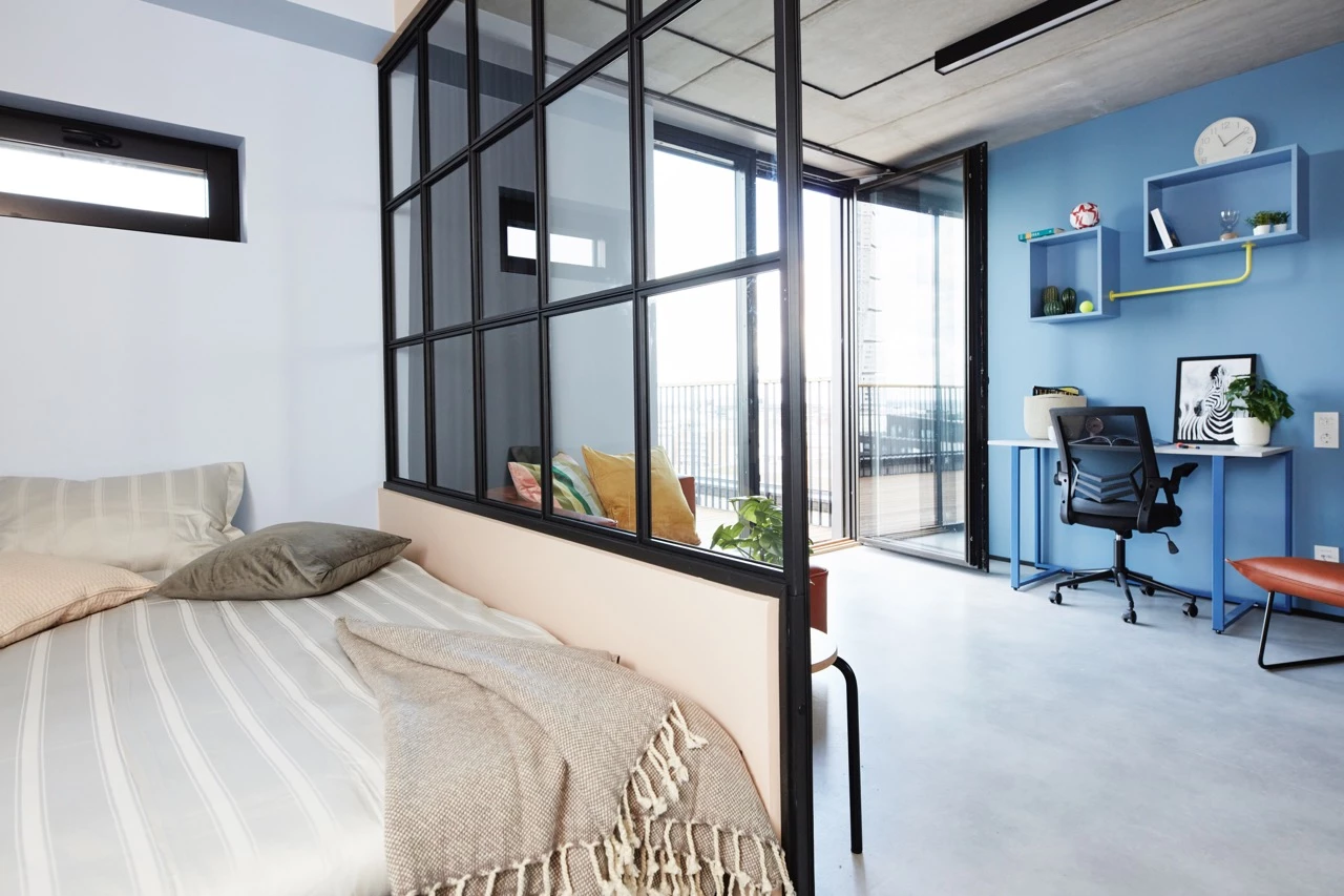 Bed and study area of a penthouse room at Basecamp Malmö student accommodation