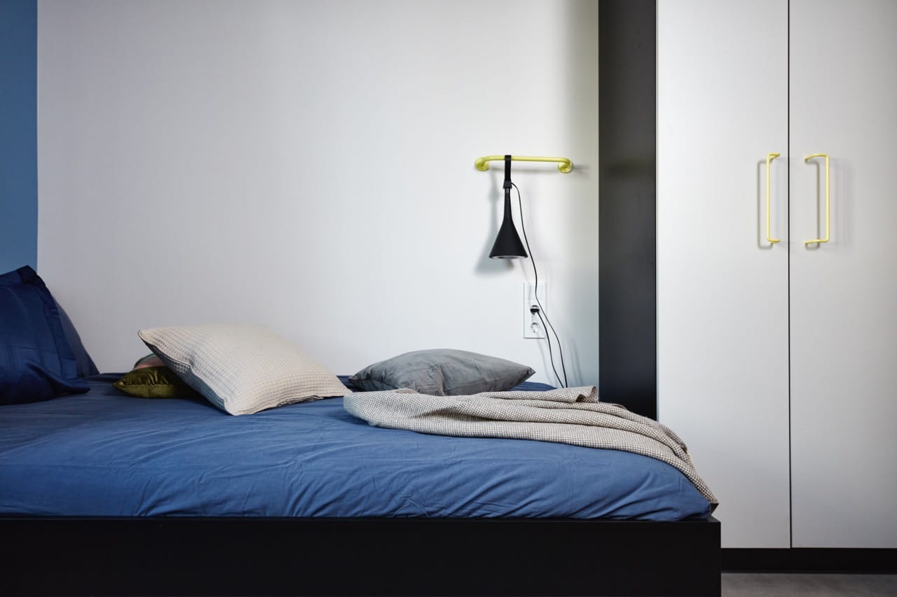 Bed and wardrobe area of a single room for students in Basecamp Malmö 