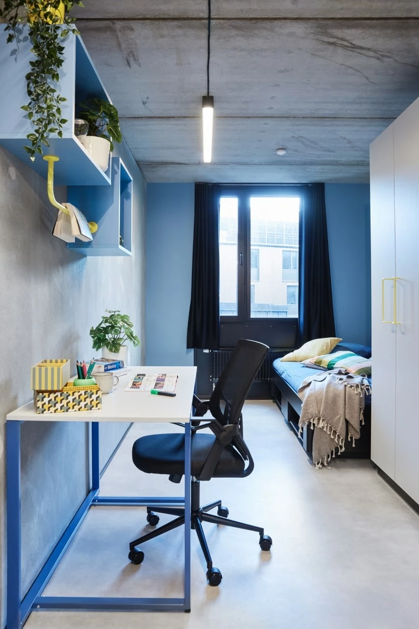 Single L room with study space, bed and storage at Basecamp Malmö student housing