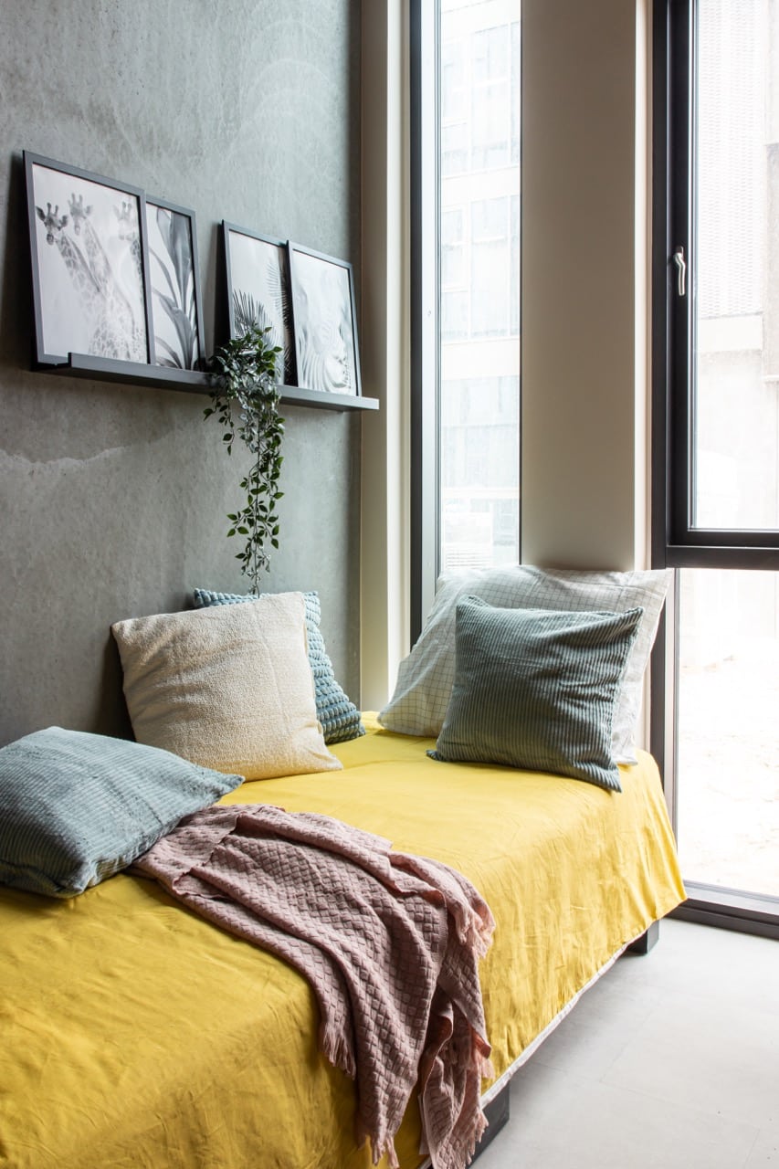 Bed in a single with kitchenette room at Basecamp Aarhus student dorm
