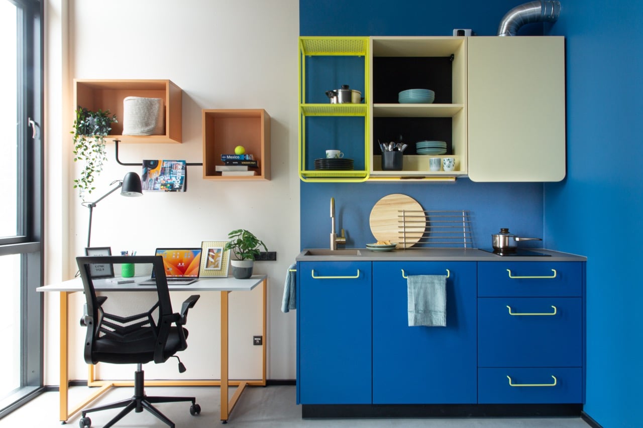 Study space and kitchenette of a studio room in Basecamp Aarhus student dorm