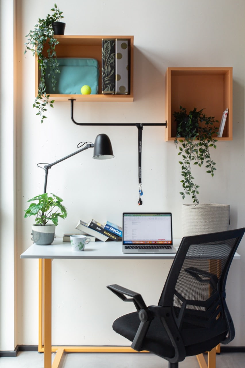 Study area with storage, desk and chair in a studio room at Basecamp aarhus student housing