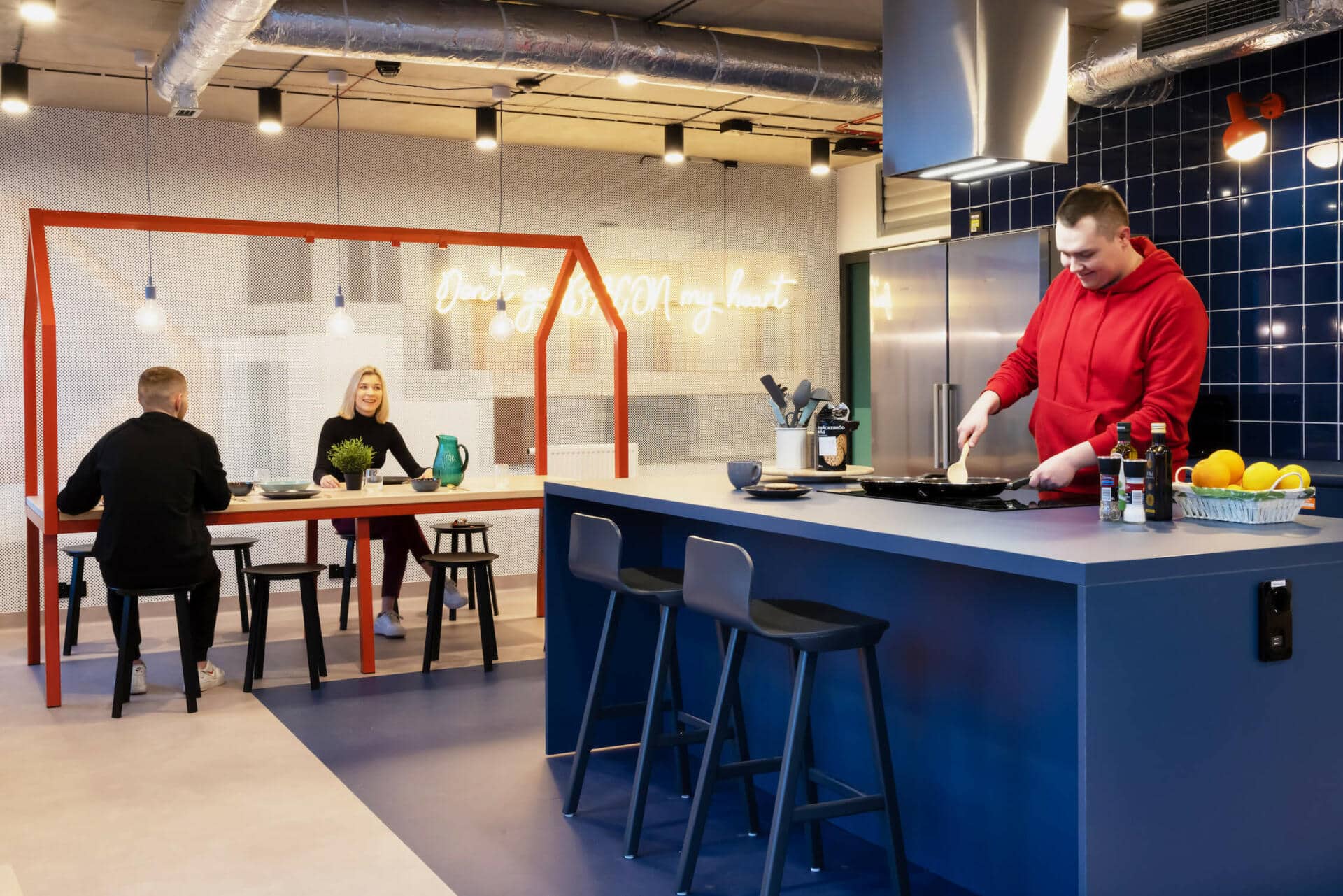 Student residents at Basecamp Katowice student dorm enjoying cooking together in one of the communal kitchens