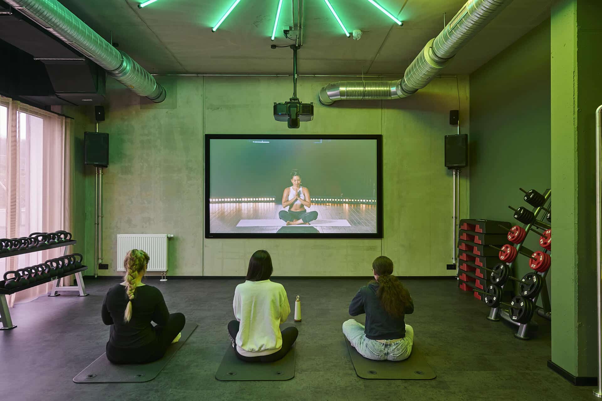 Students meditate during a yoga sessions at Basecamp Gottingen's fitness room