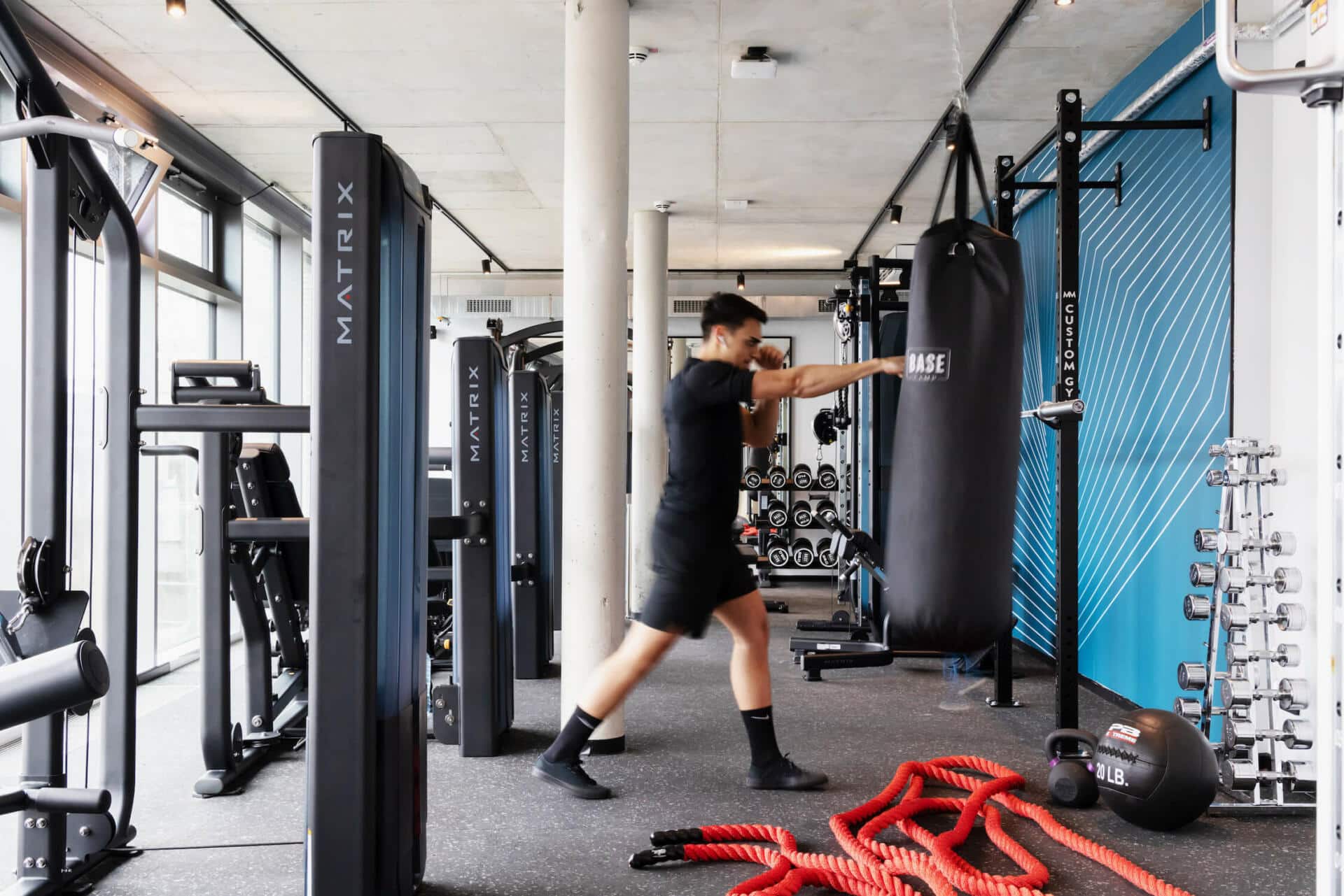 A student trains with a punching bag at Basecamp Dortmund dormitory's gym