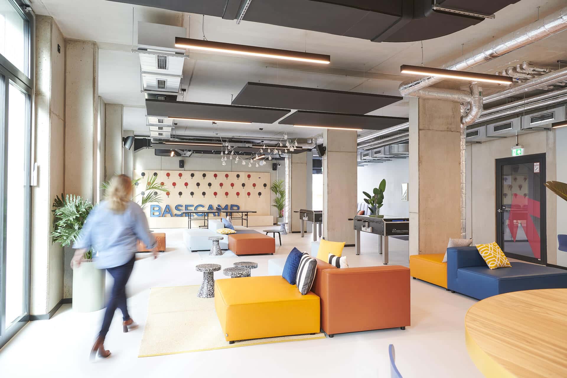 A relax area at Basecamp Gottingen student accommodation with table football and colourful sofas