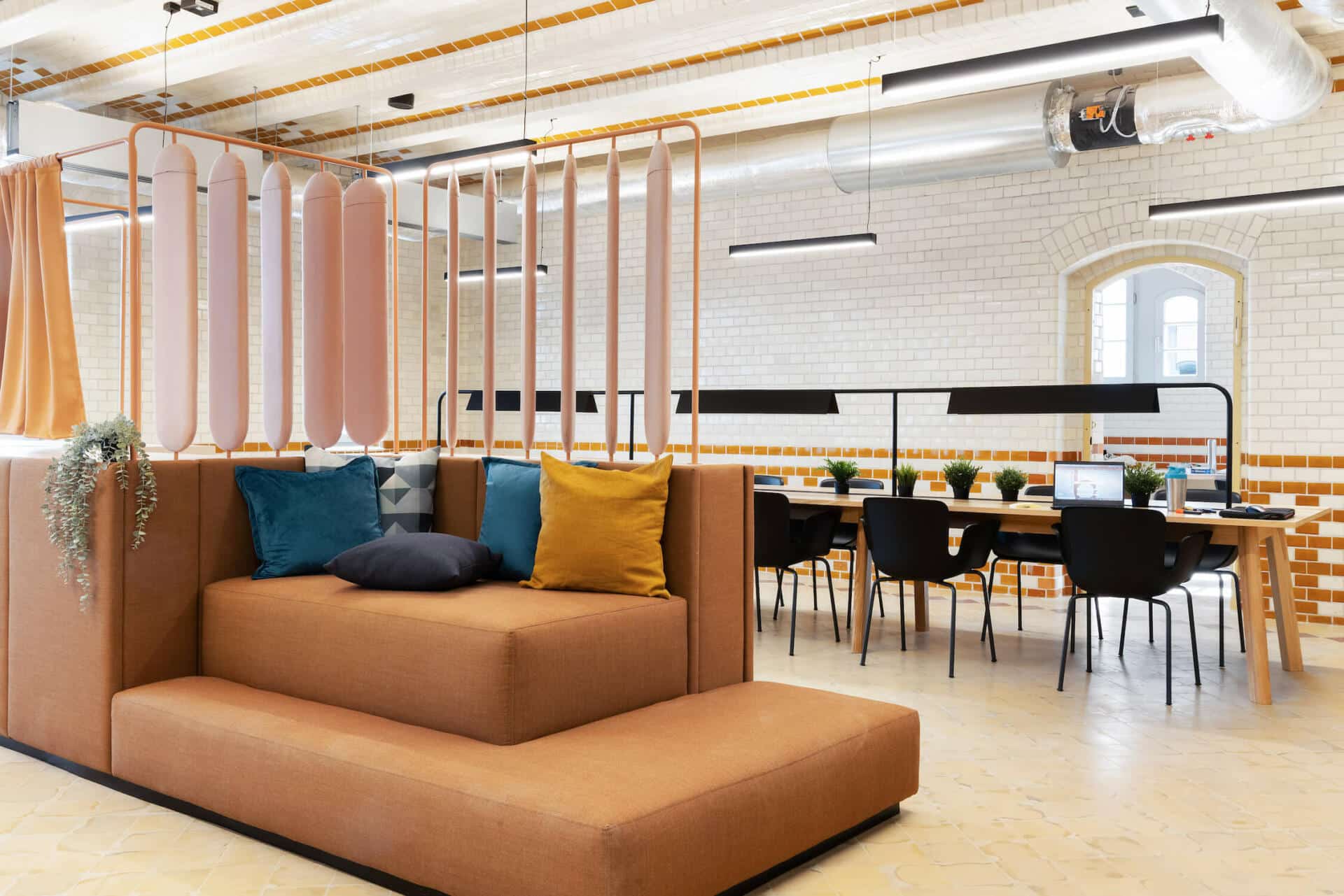 Shared study space with comfortable sofas and tables at Basecamp Wroclaw student housing