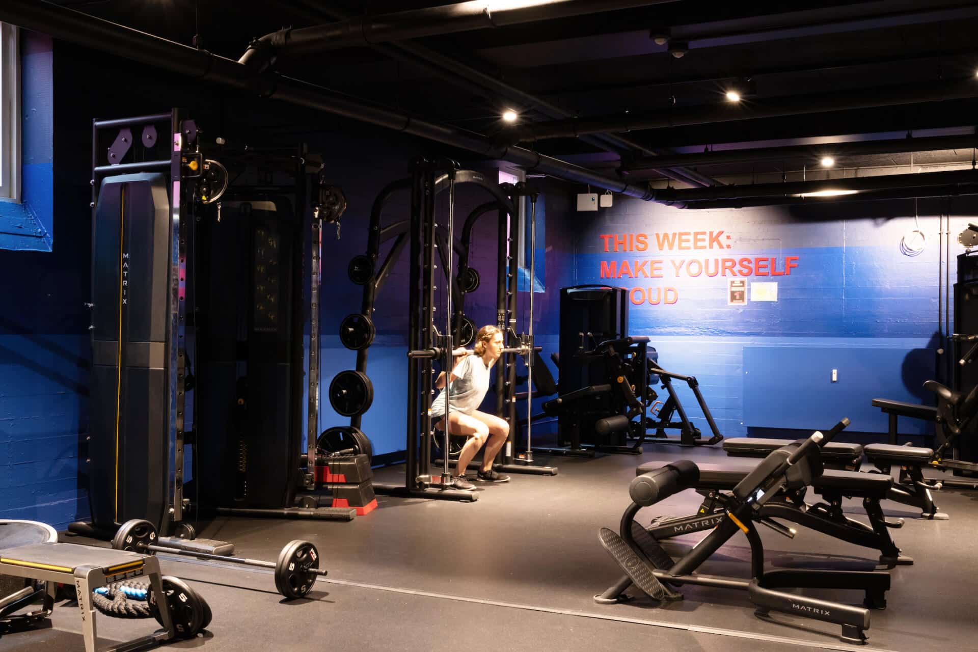 Free weights area with racks and gym machines in the large, state of the art gym at Basecamp Copenhagen Student housing