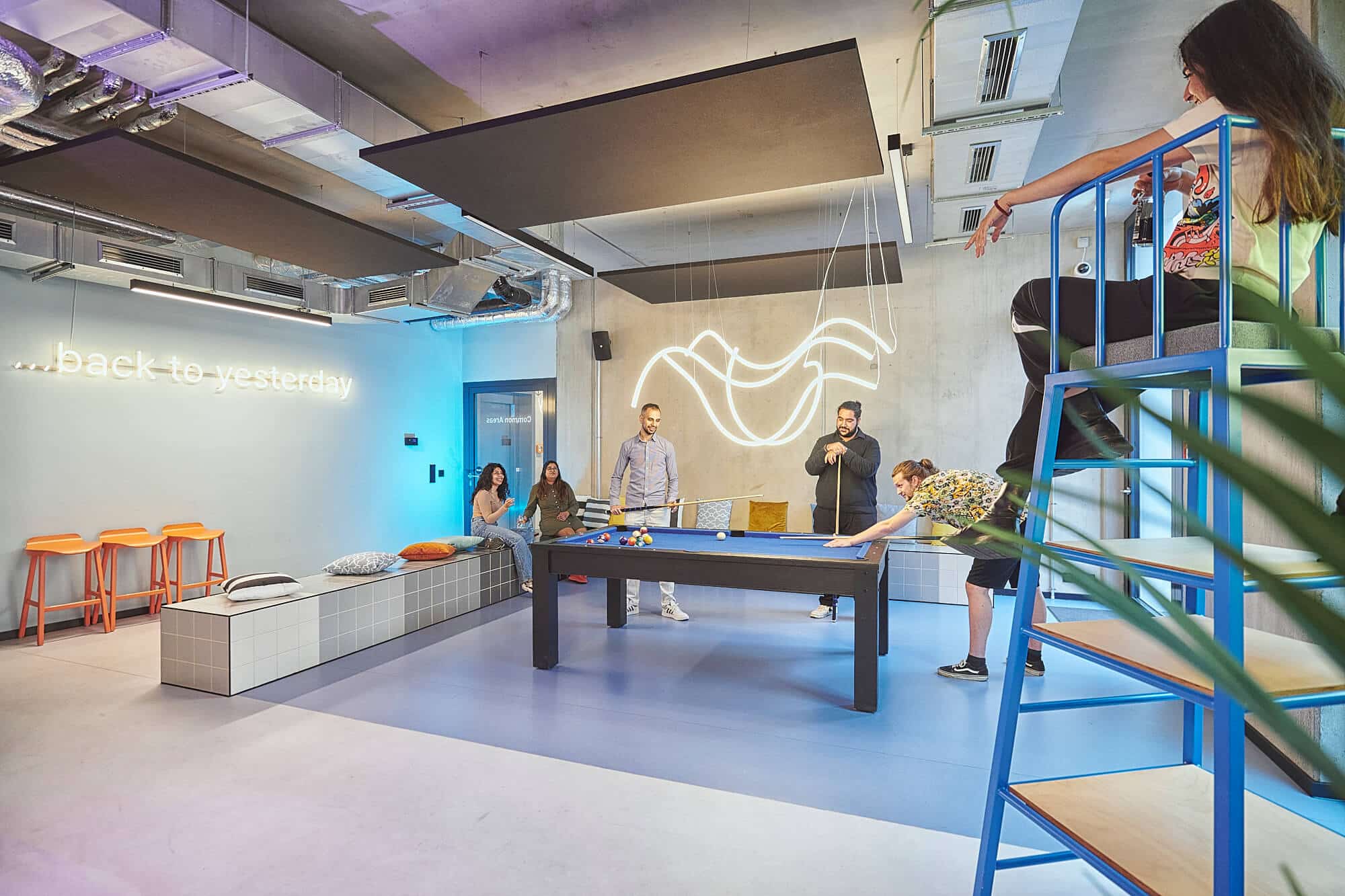 Students play pool in a game zone of Basecamp Gottingen student accommodation