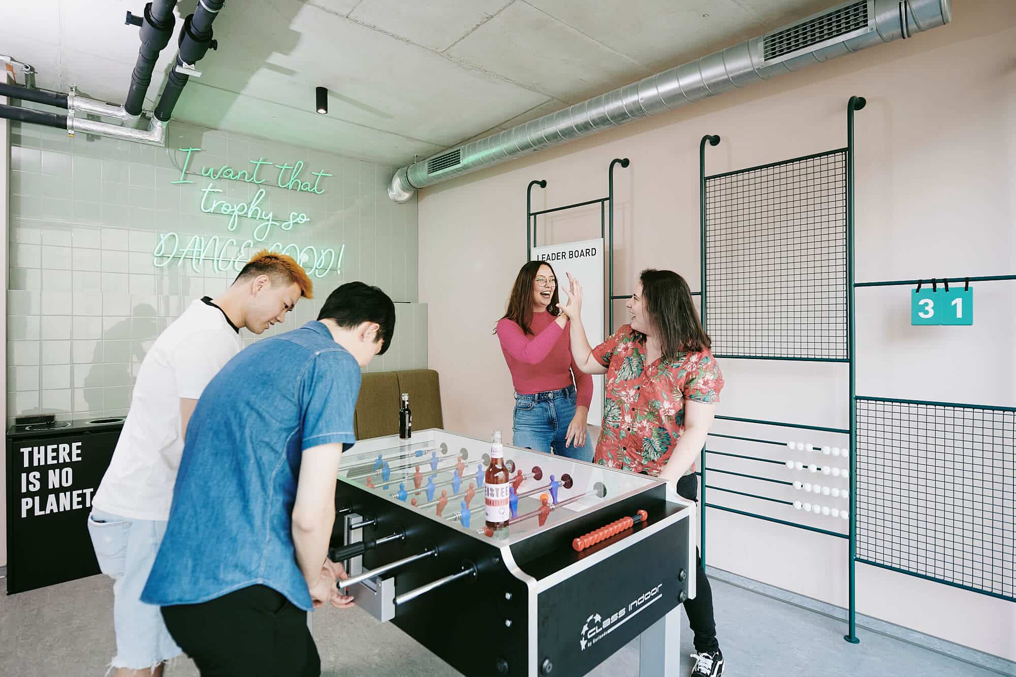 Students playing table football in a Game Zone at Basecamp Dortmund student accommodation