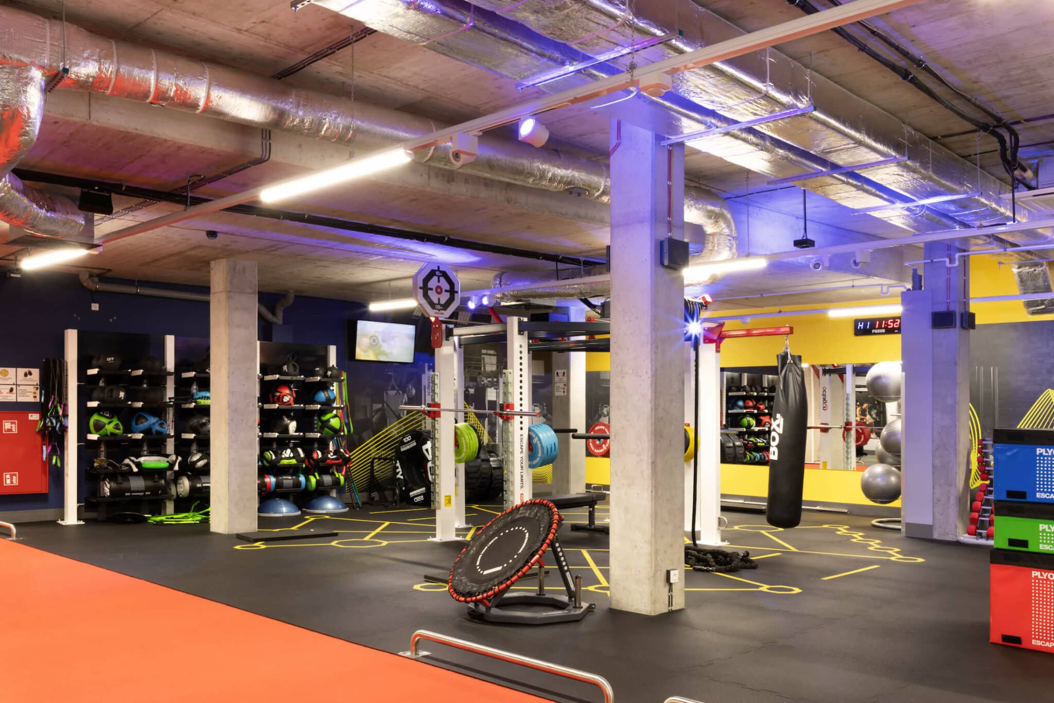 Free weights area with racks, medicine balls and boxing bag in the large, state of the art gym at Basecamp Łódź Rembielińskiego Student housing