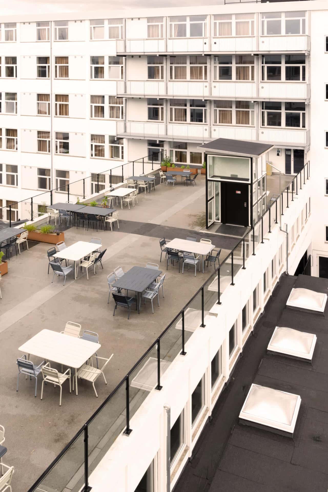 Roof terrace with tables to chill at Basecamp Copenhagen student dormitory