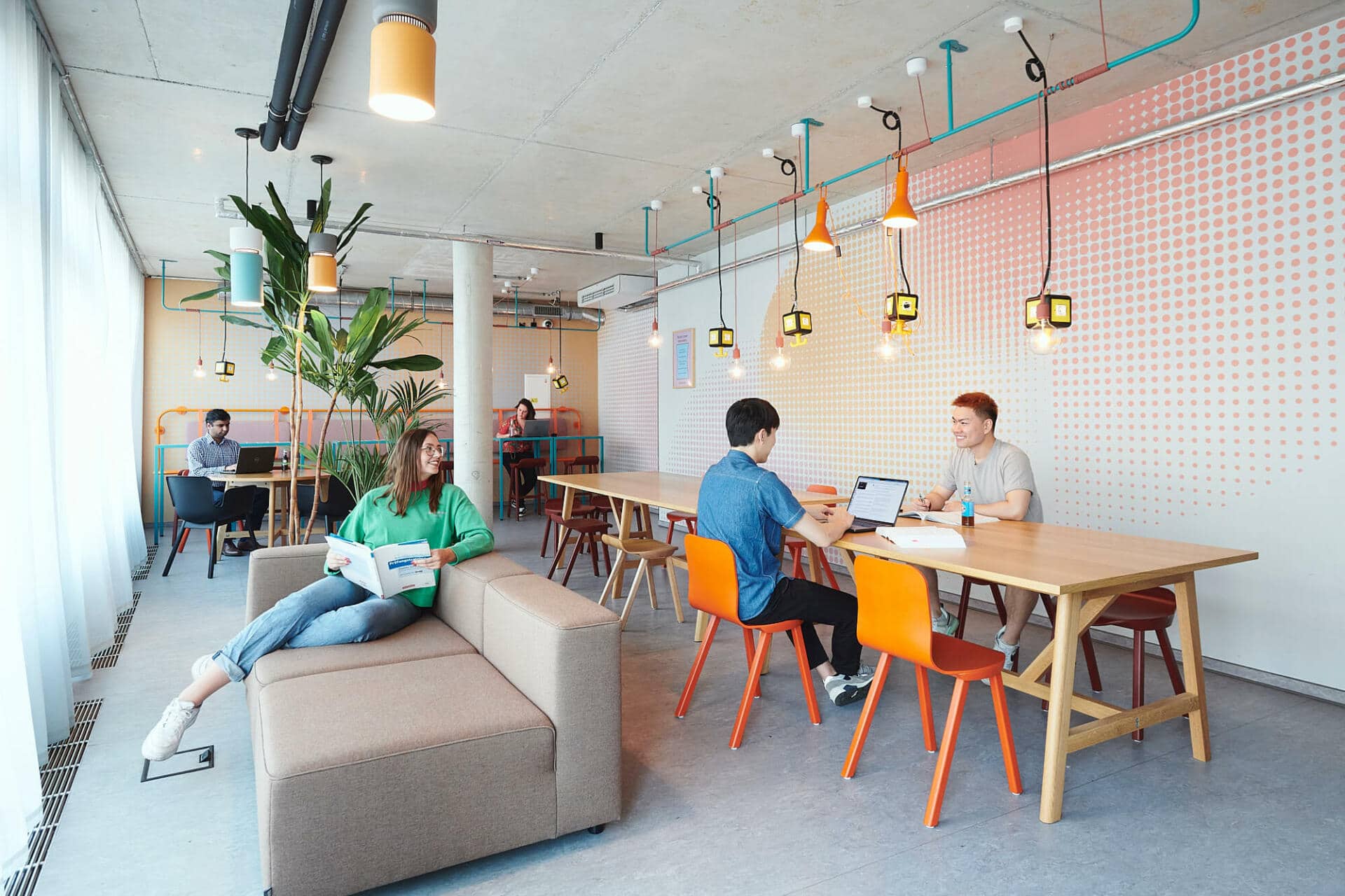 Students read and work in a study space at Basecamp Dortmund student accommodation