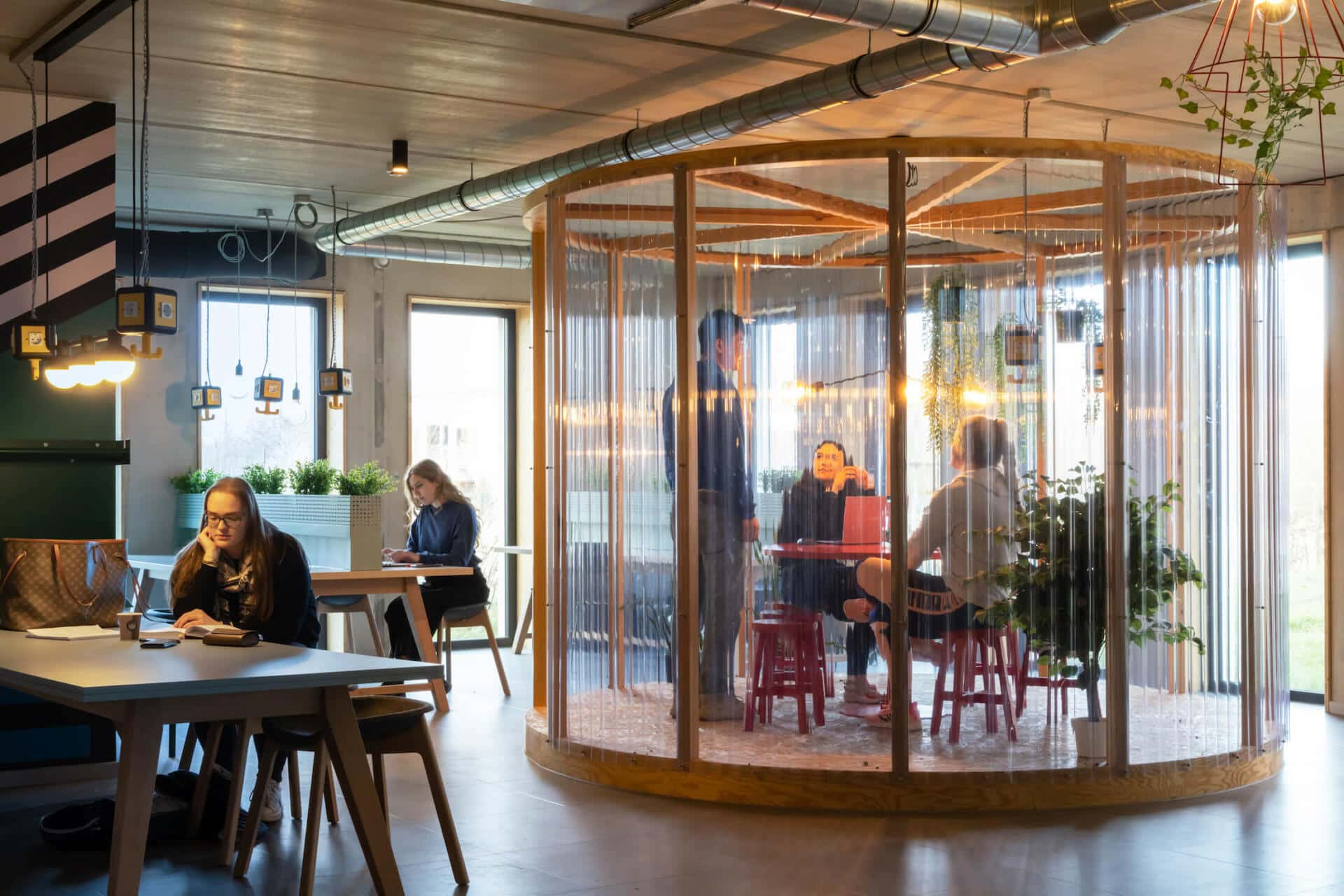 Students read and work in a study space at Basecamp Potsdam student accommodation