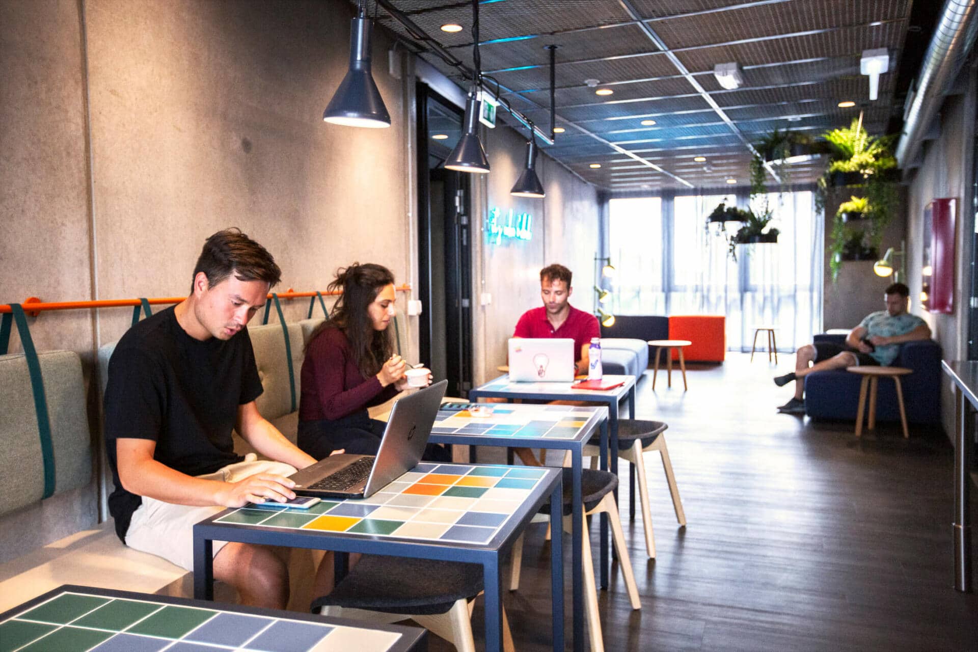 students doing university work and eating in the common kitchen at Basecamp Lyngby student accommodation