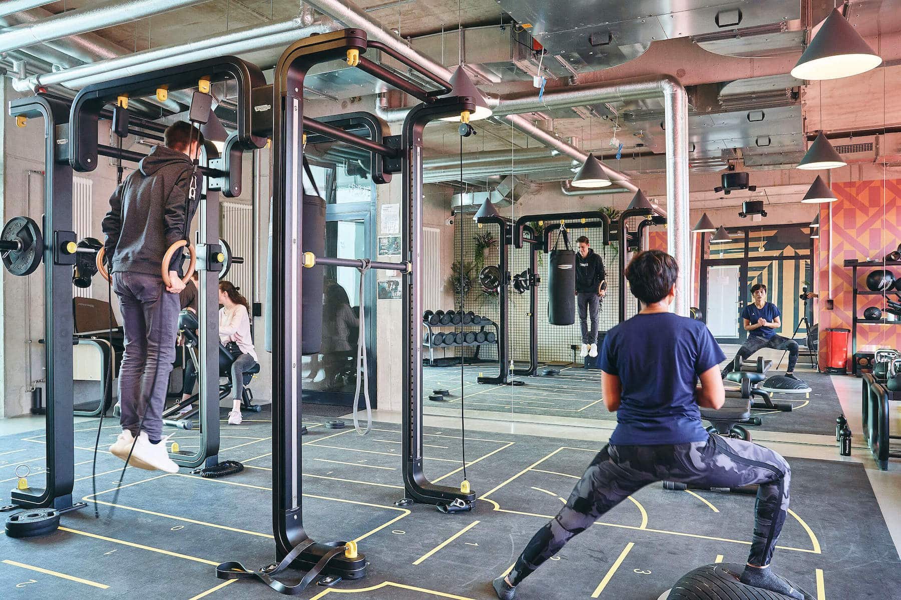 sudents work out i with weights and machines in our state of the art gym at Basecamp Leipzig student dormitory