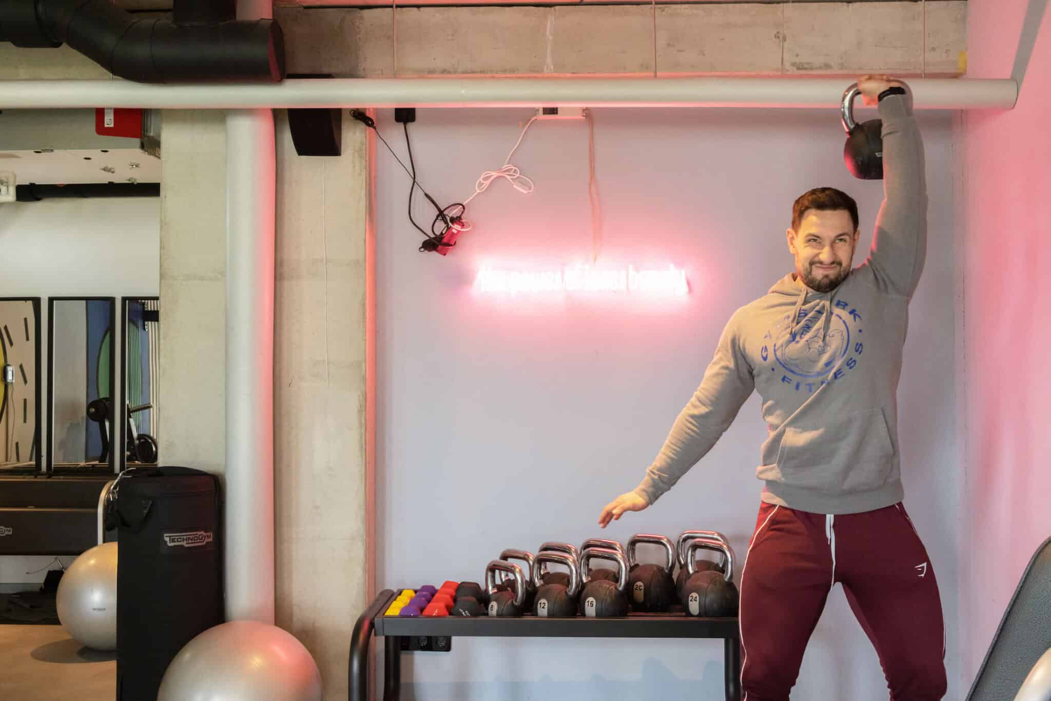 sudent works out with weights in our state of the art gym at Basecamp Potsdam student dormitory