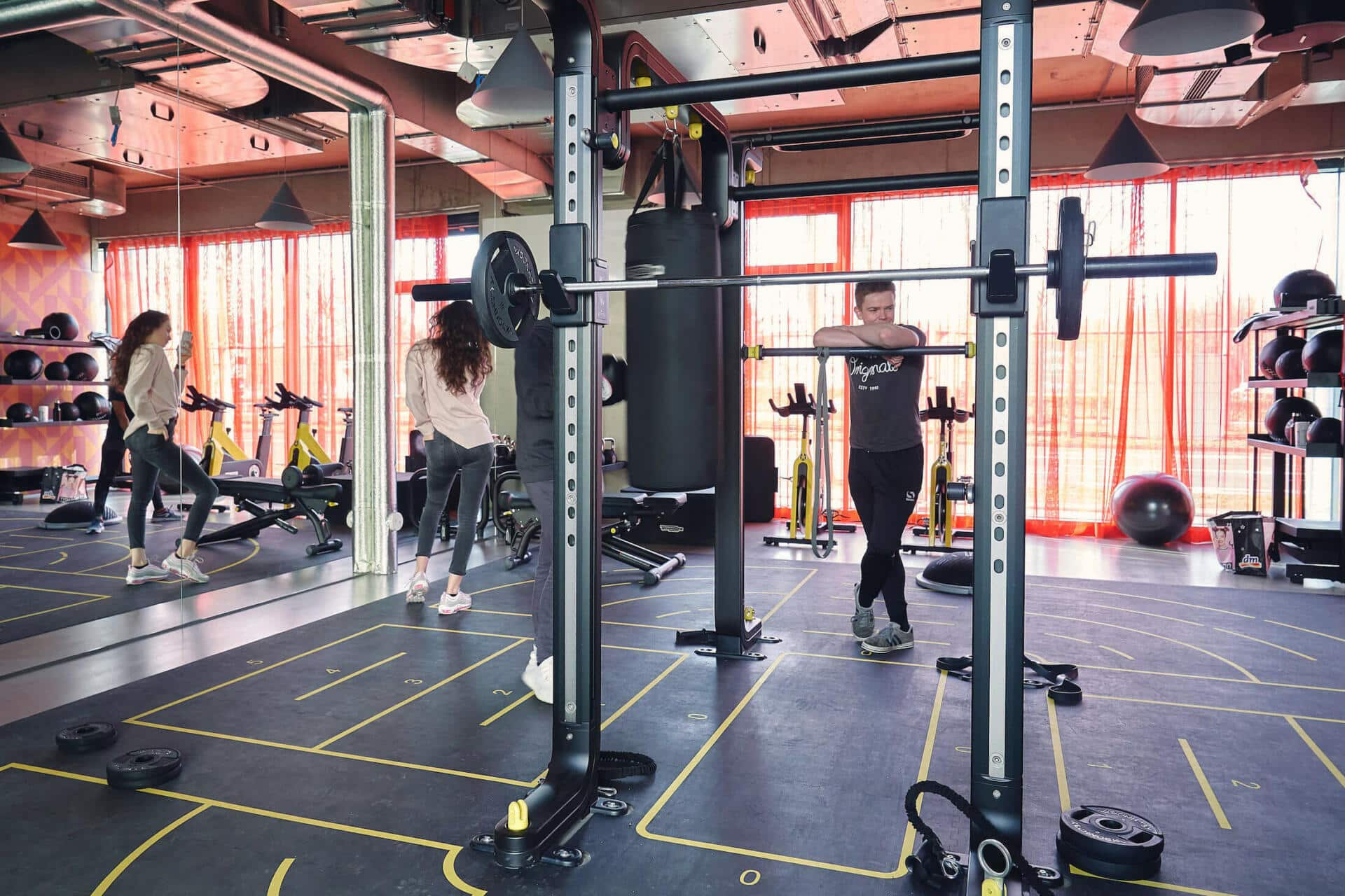 Two students work out in the modern gym at Basecamp Leipzig student housing