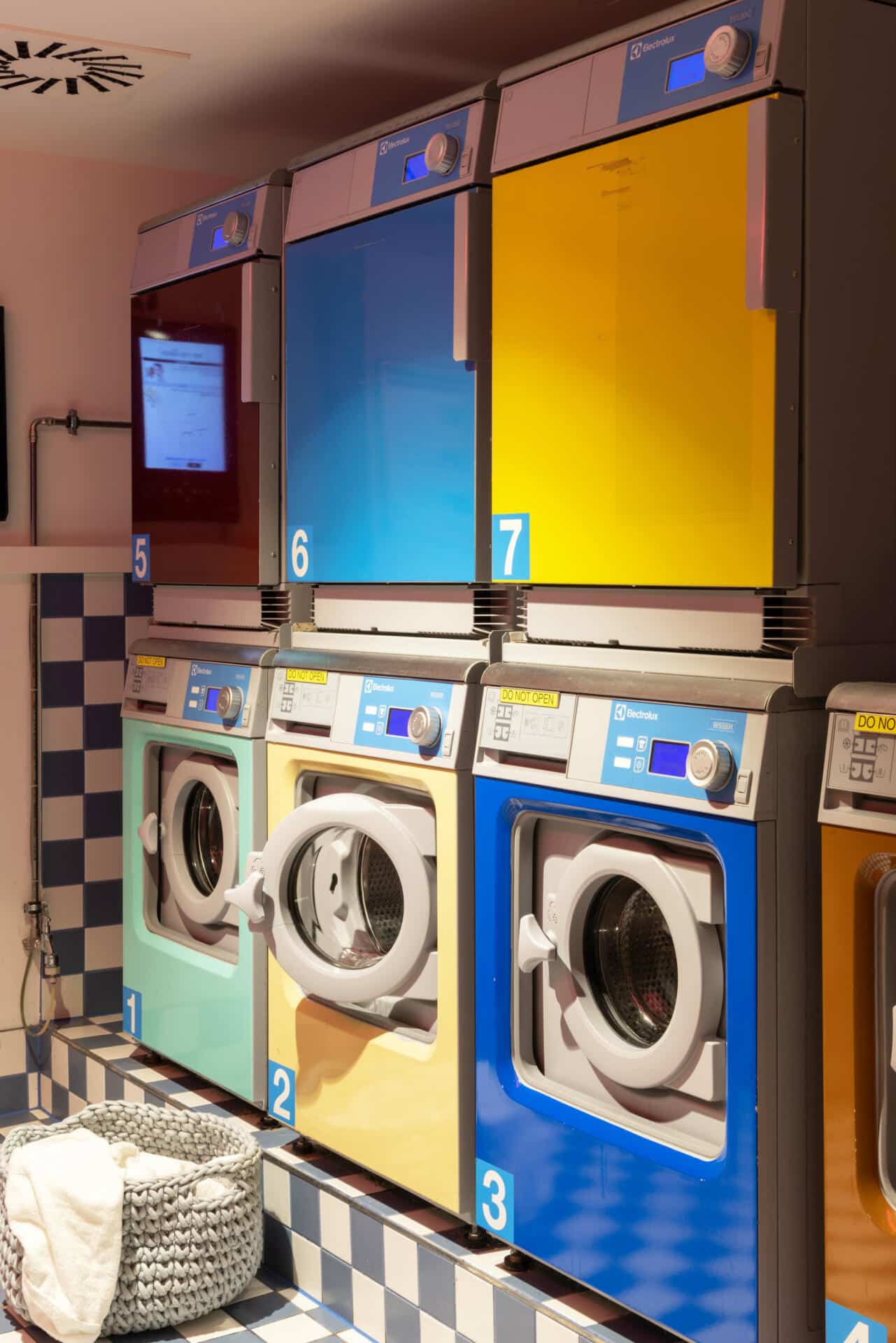 Colourful laundry machines and dryers in the Laundry Room at Basecamp Potsdam student accommodation