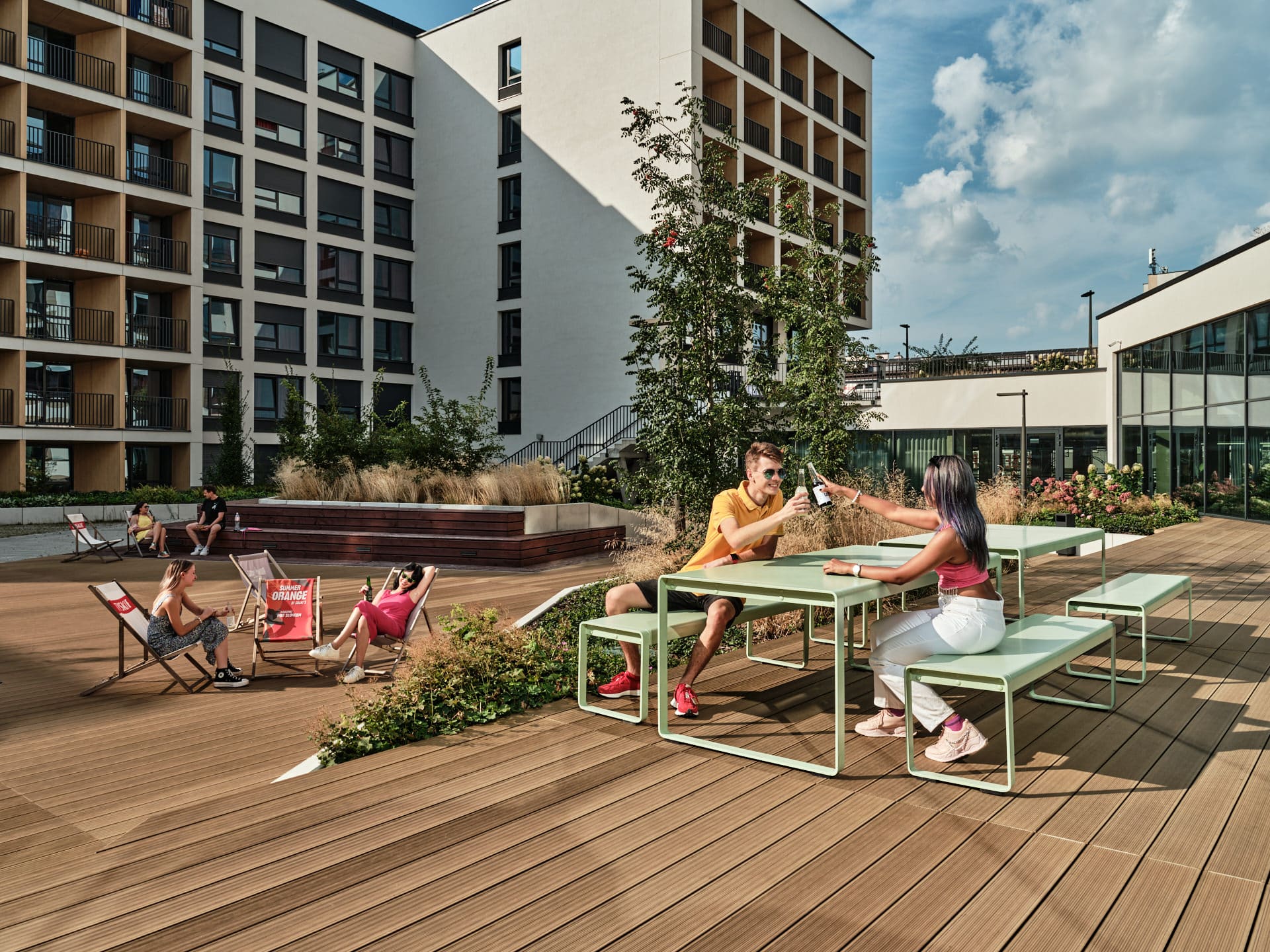 people sitting and drinking outside of Basecamp Wroclaw Student housing