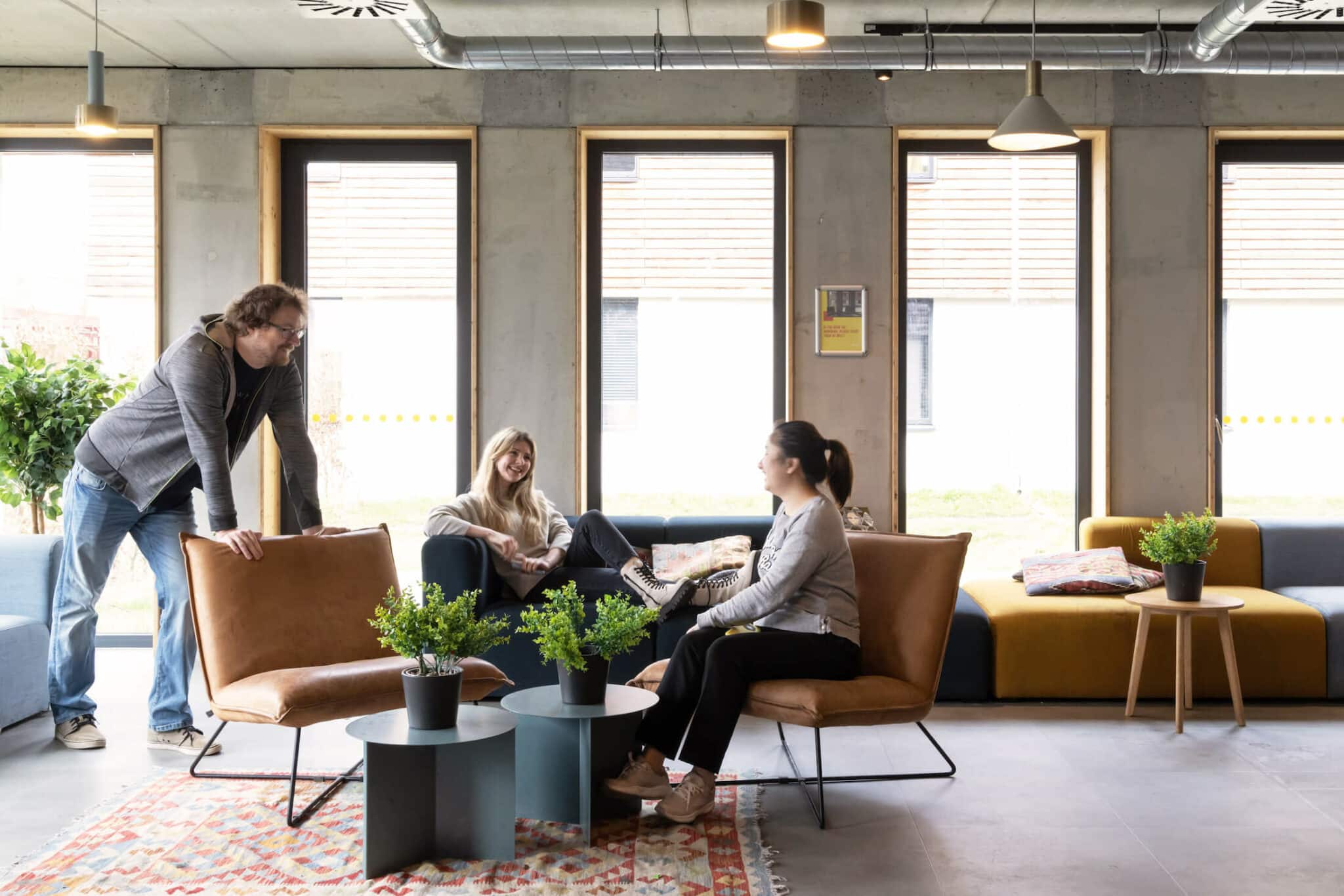 Students hang out on sofas in a Relax Zone at Basecamp Potsdam student accommodation