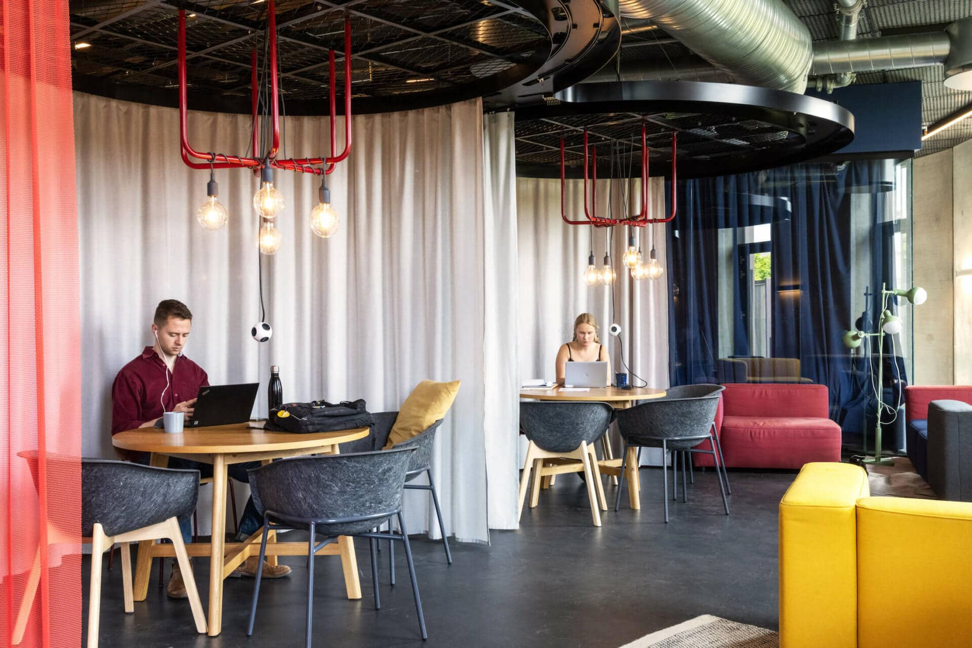 two students doing university work in the communal study area at Basecamp Lyngby student accommodation