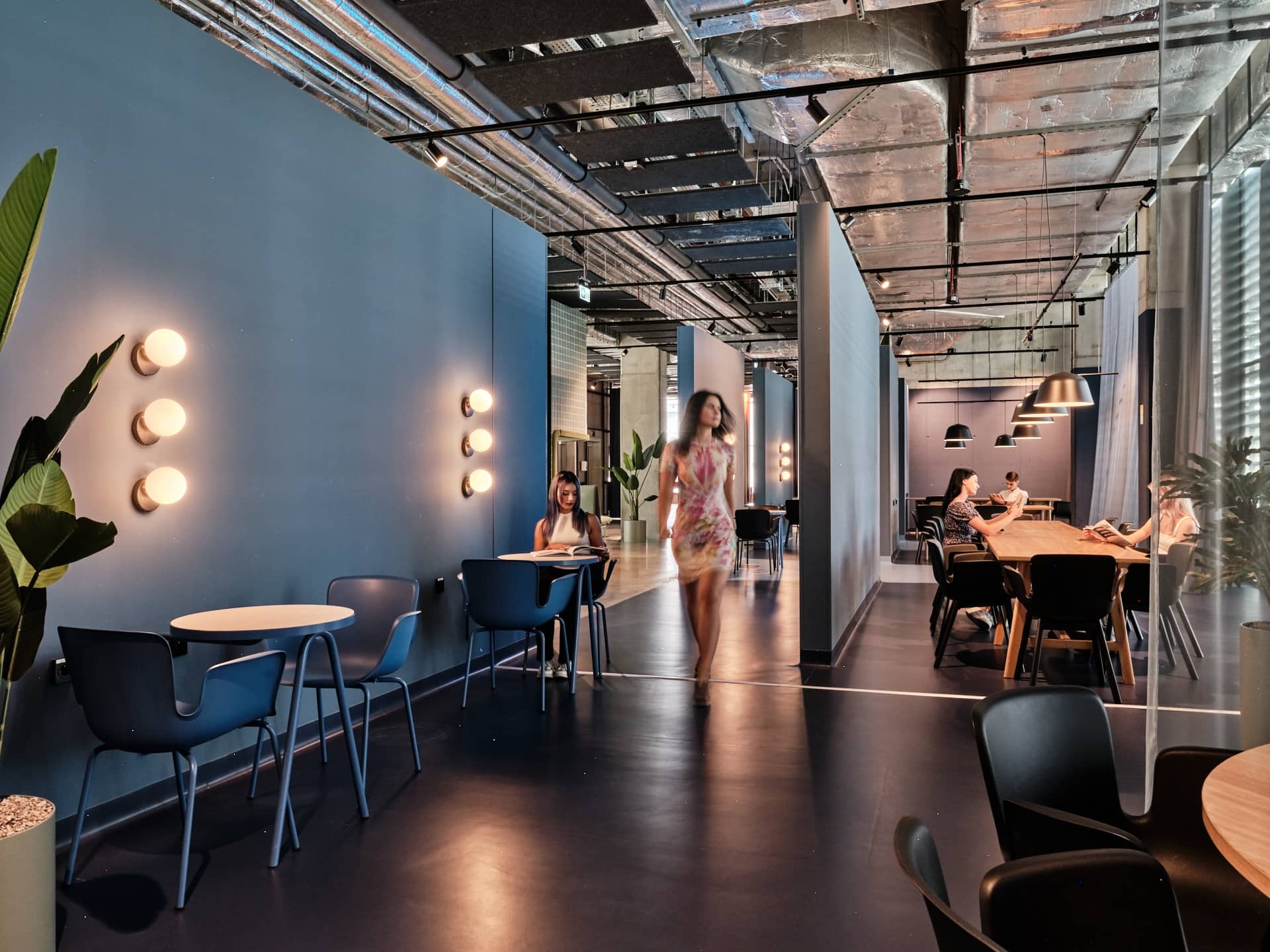 Students read in a communal study space at Basecamp Katowice dormitory