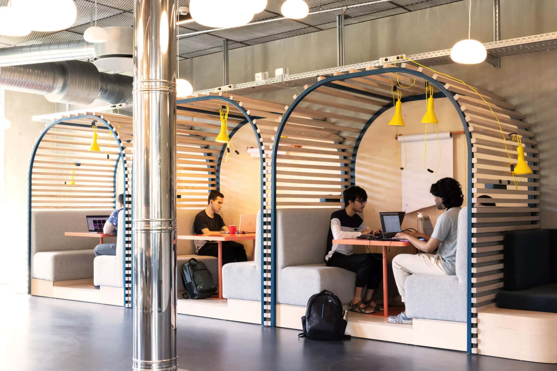 a group of studentsdoing university work in the communal study area at Basecamp Lyngby student accommodation